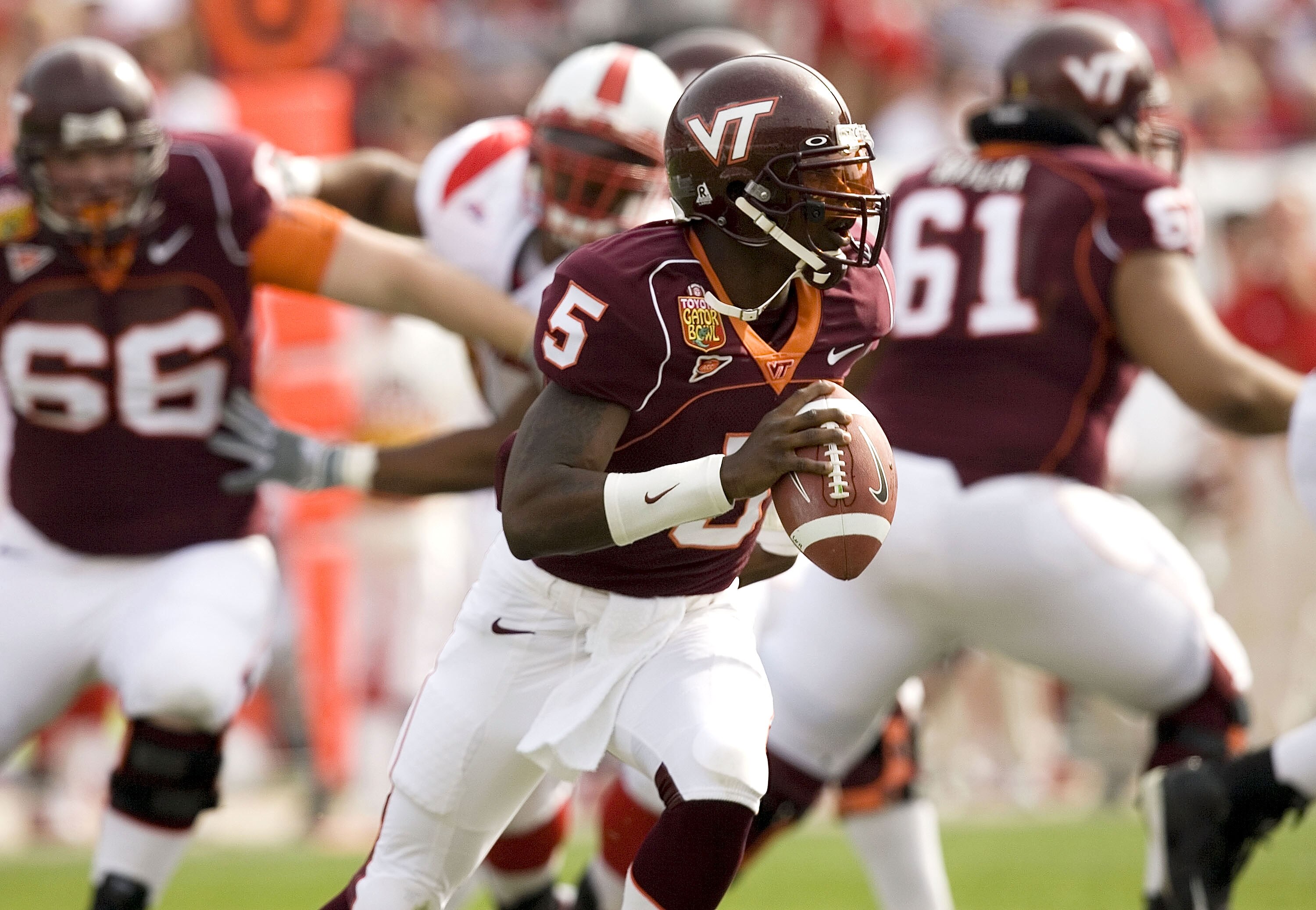 JACKSONVILLE, FL - JANUARY 2:  Marcus Vick #5 of the Virginia Tech Hokies scrambles against the Louisville Cardinals during the Toyota Gator Bowl on January 2, 2006 at Alltel Stadium in Jacksonville, Florida.  (Photo by Matt Stroshane/Getty Images)