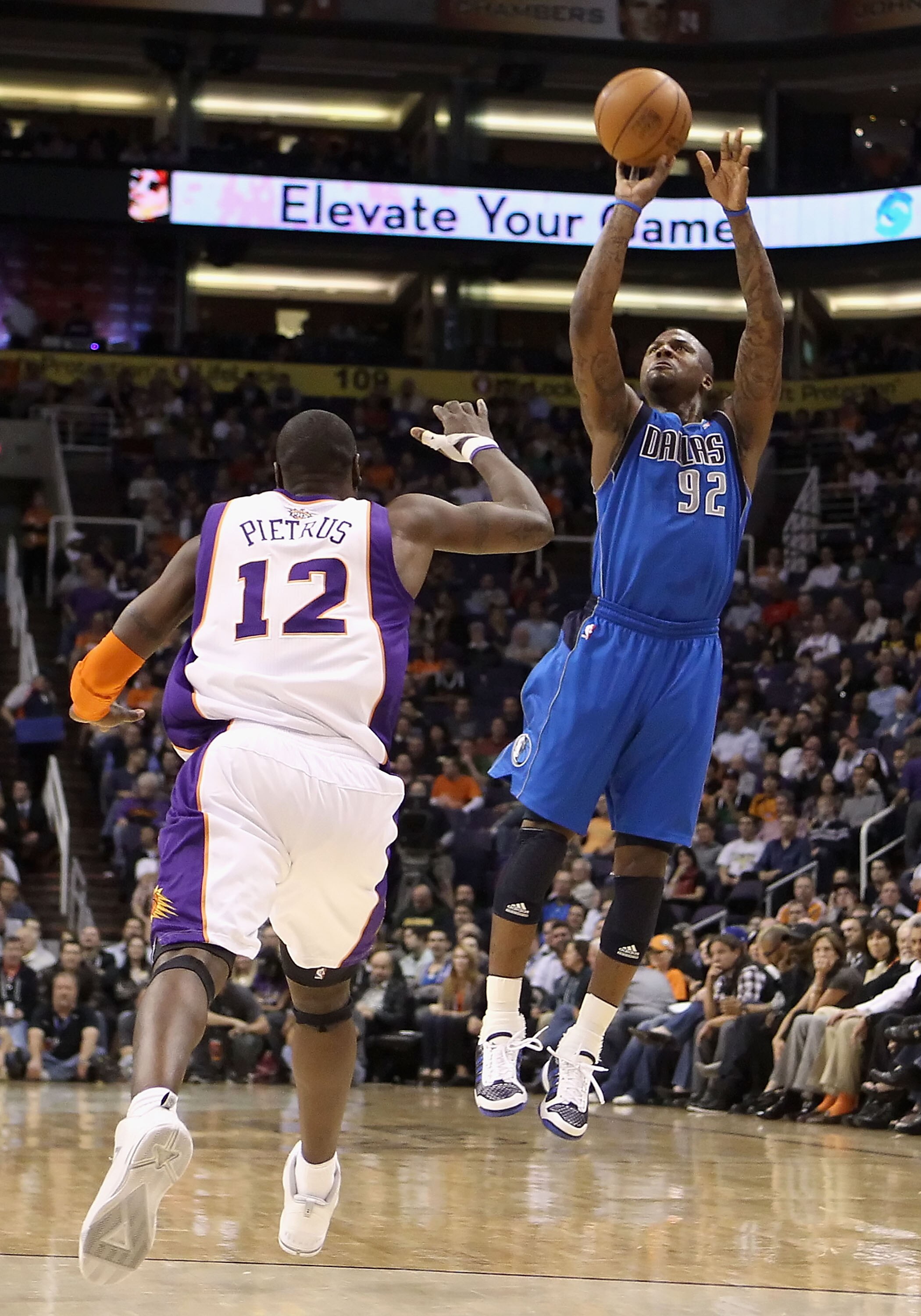 PHOENIX, AZ - FEBRUARY 17:  DeShawn Stevenson #92 of the Dallas Mavericks attempts a three point shot over Mickael Pietrus #12 of the Phoenix Suns during the NBA game at US Airways Center on February 17, 2011 in Phoenix, Arizona.  The Mavericks defeated t