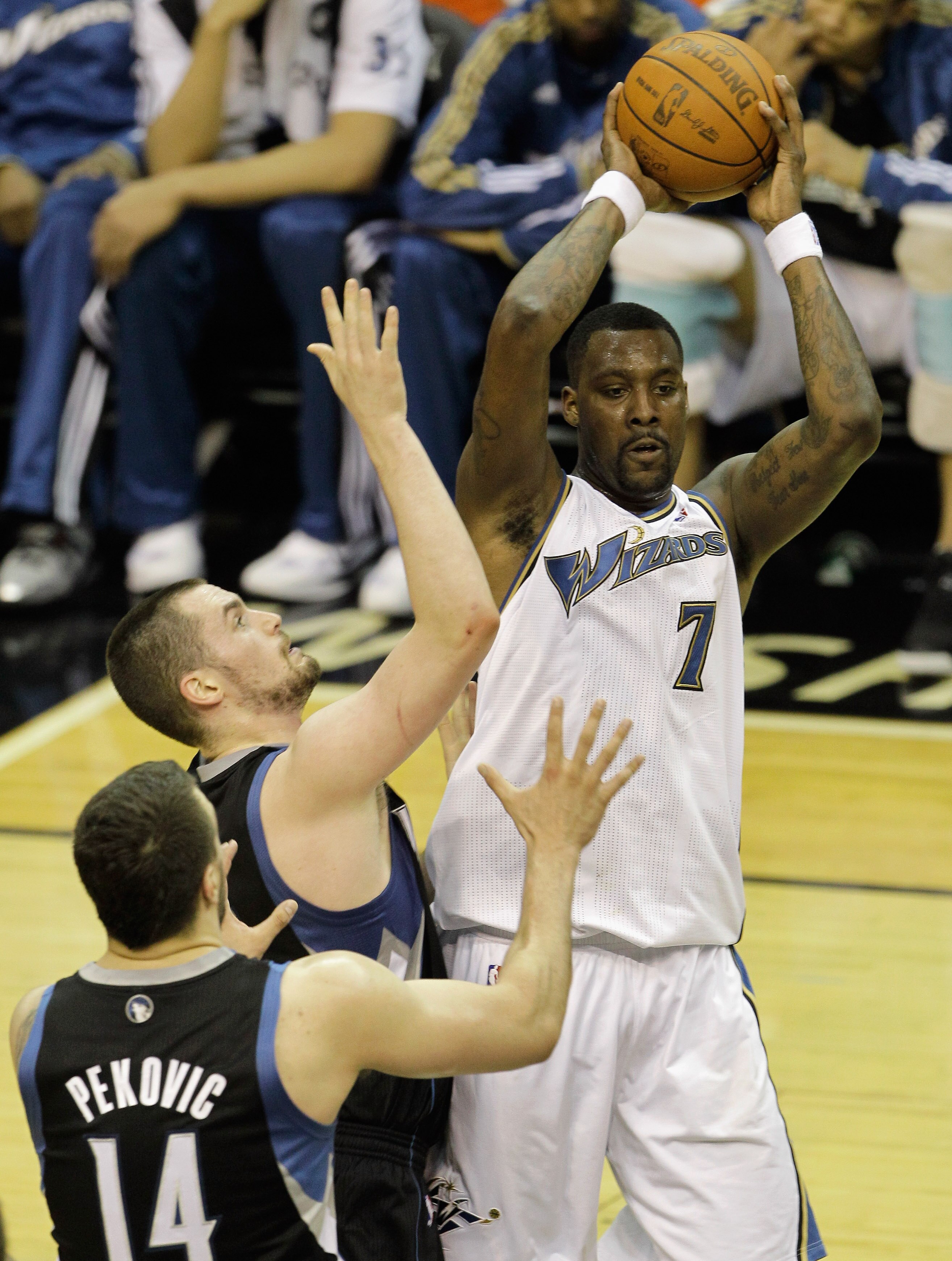 WASHINGTON, DC - MARCH 05:  Andray Blatche #7 of the Washington Wizards passes the ball while being guarded by Kevin Love #42 and Nikola Pekovic #14 of the Minnesota Timberwolves at the Verizon Center on March 5, 2011 in Washington, DC. NOTE TO USER: User