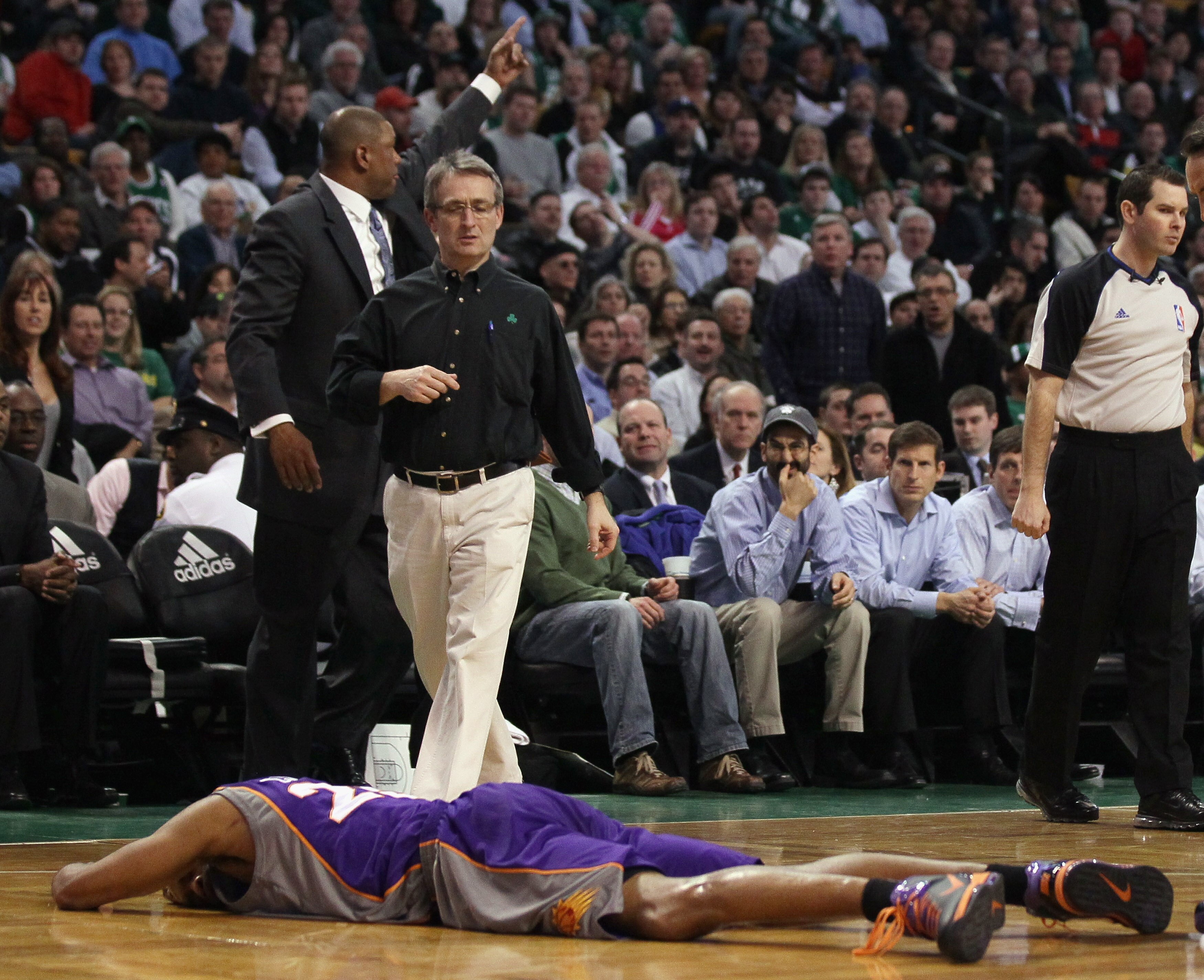 BOSTON, MA - MARCH 02: Vince Carter #25 of the Phoenix Suns lies on the court as Doc Rivers of the Boston Celtics signals to the Suns bench on March 2, 2011 at the TD Garden in Boston, Massachusetts. Carter did not return to the game. The Celtics defeated