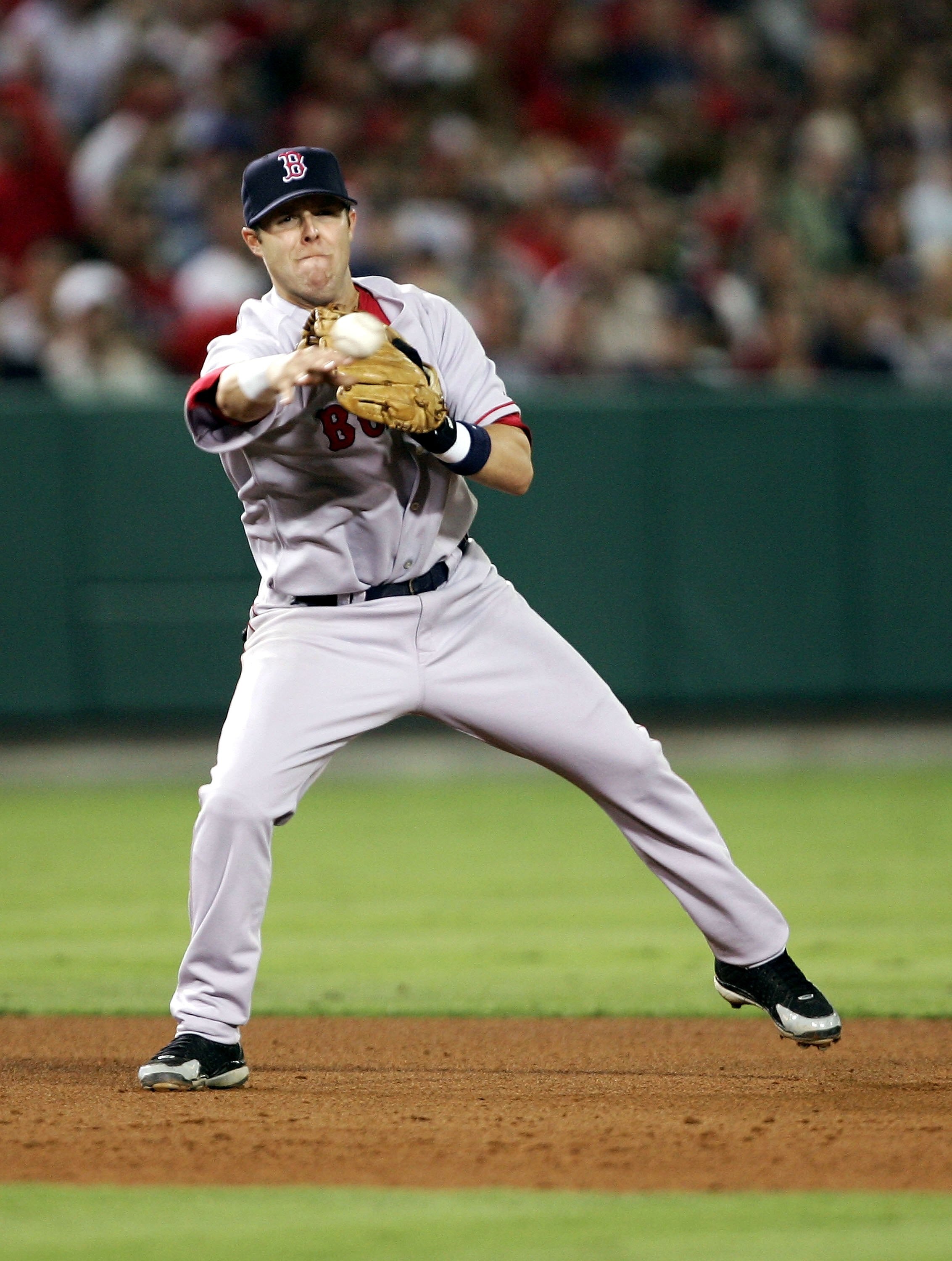 ANAHEIM, CA - AUGUST 22:  Dustin Pedroia #64 of the Boston Red Sox starts a double play in the seventh inning against the Los Angeles Angels of Anaheim in his first Major League game at Anaheim Stadium August 22, 2006 in Anaheim, California.  (Photo by Ha