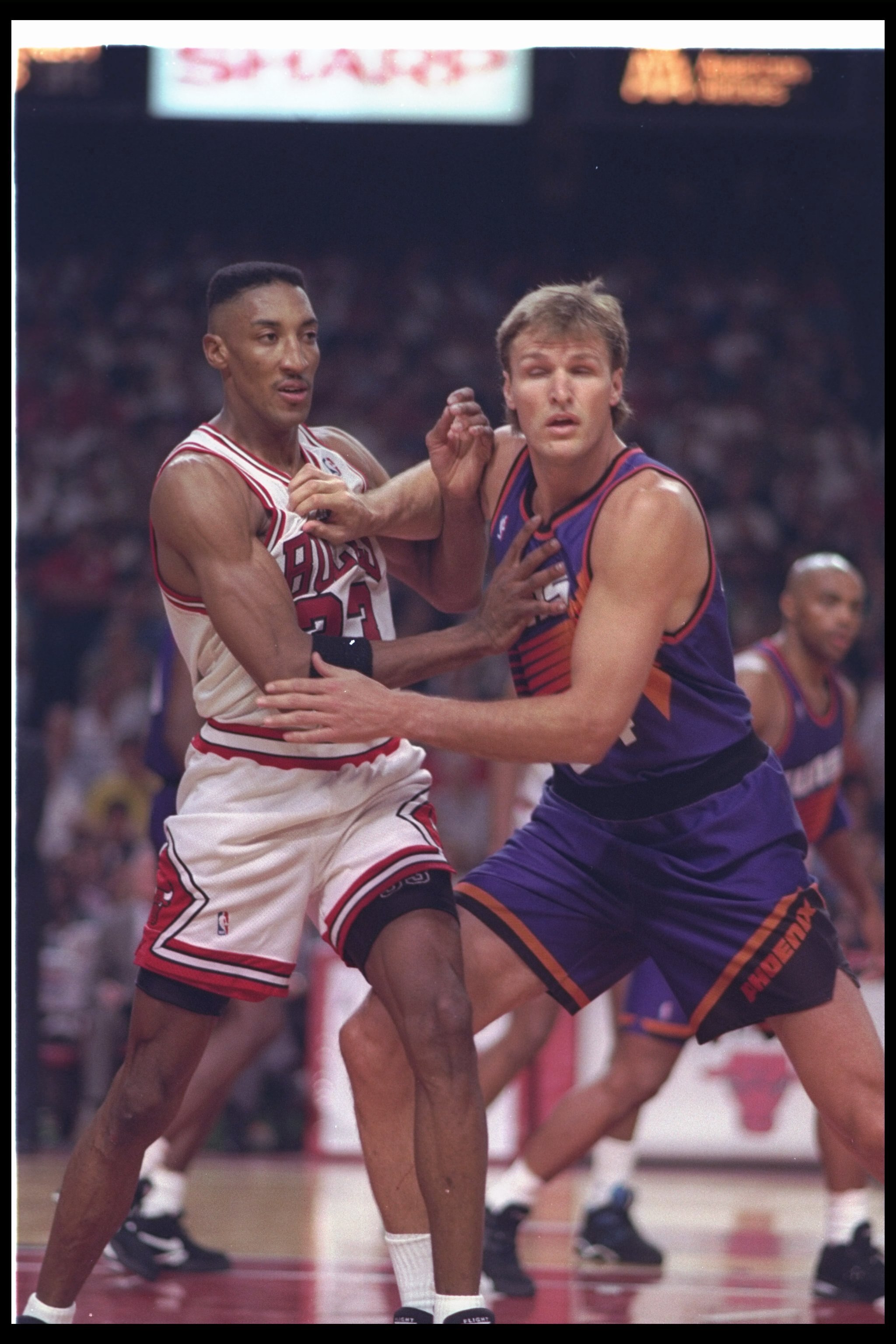 13 Jun 1993: Forward Scottie Pippen of the Chicago Bulls (left) and forward Tom Chambers of the Phoenix Suns tangle up during Game Three of the NBA finals at the United Center in Chicago, Illinois. The Suns won the game, 129-121.