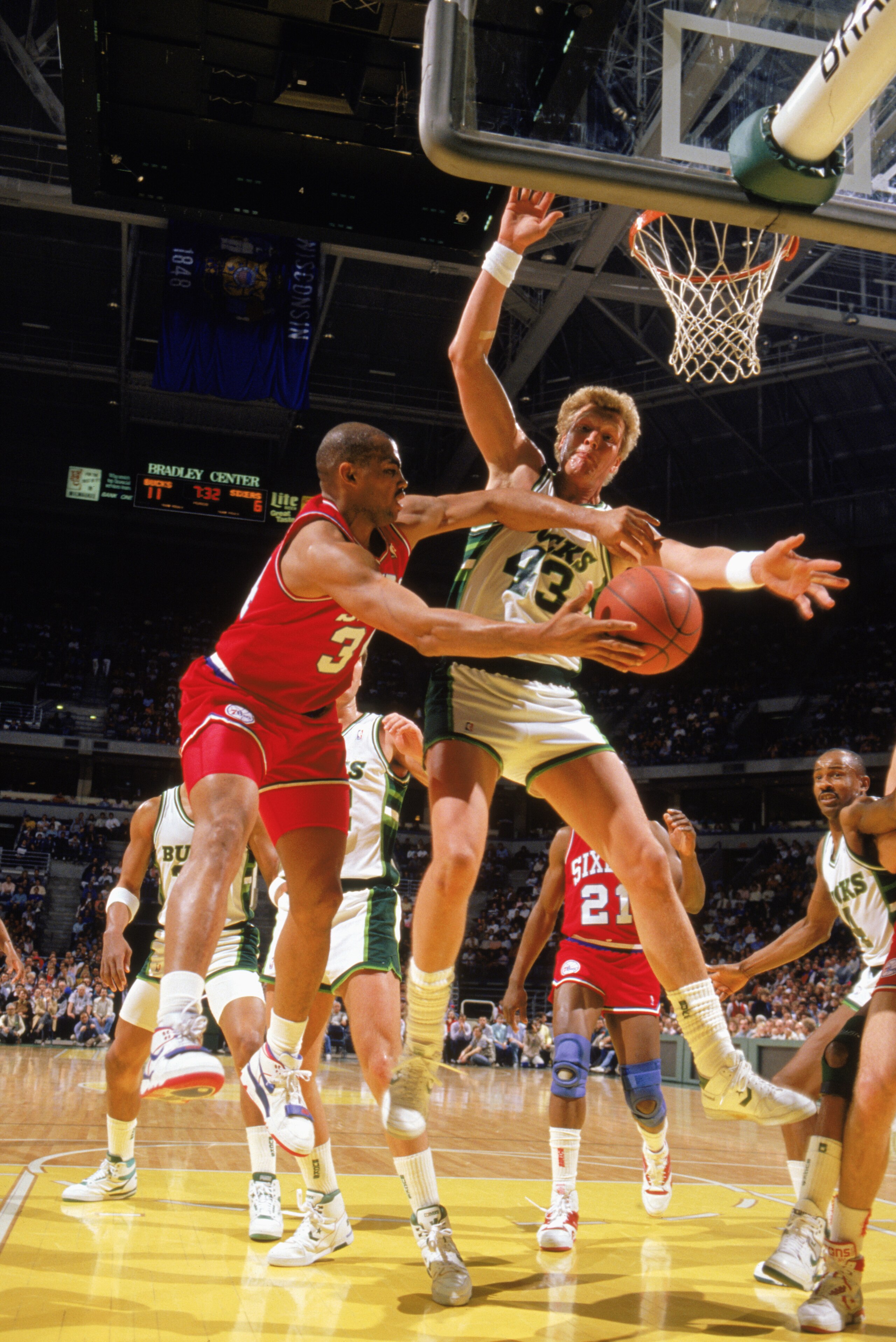 MILWAUKEE - 1989:  Charles Barkley #34 of the Philadelphia 76ers attempts to pass the ball around Jack Sikma #43 of the Milwaukee Bucks during the 1988-1989 NBA season game at the Bradley Center in Milwaukee Wisconsin.  (Photo by /Getty Images)
