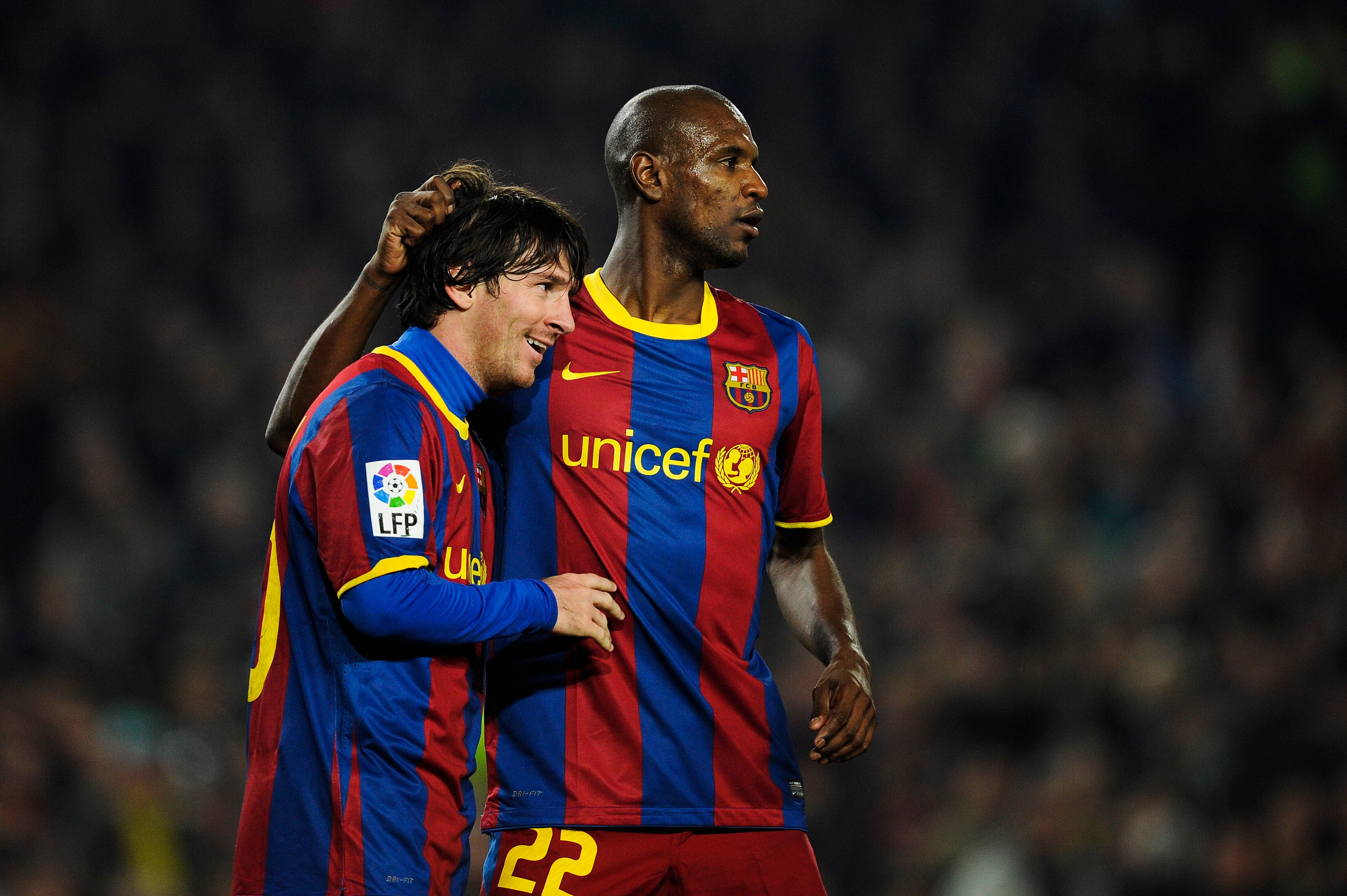 BARCELONA, SPAIN - FEBRUARY 05:  Lionel Messi of Barcelona (L) celebrates with his teammate Eric Abidal after scoring his third goal during the La Liga match between Barcelona and Atletico de Madrid at Camp Nou on February 5, 2011 in Barcelona, Spain. Bar