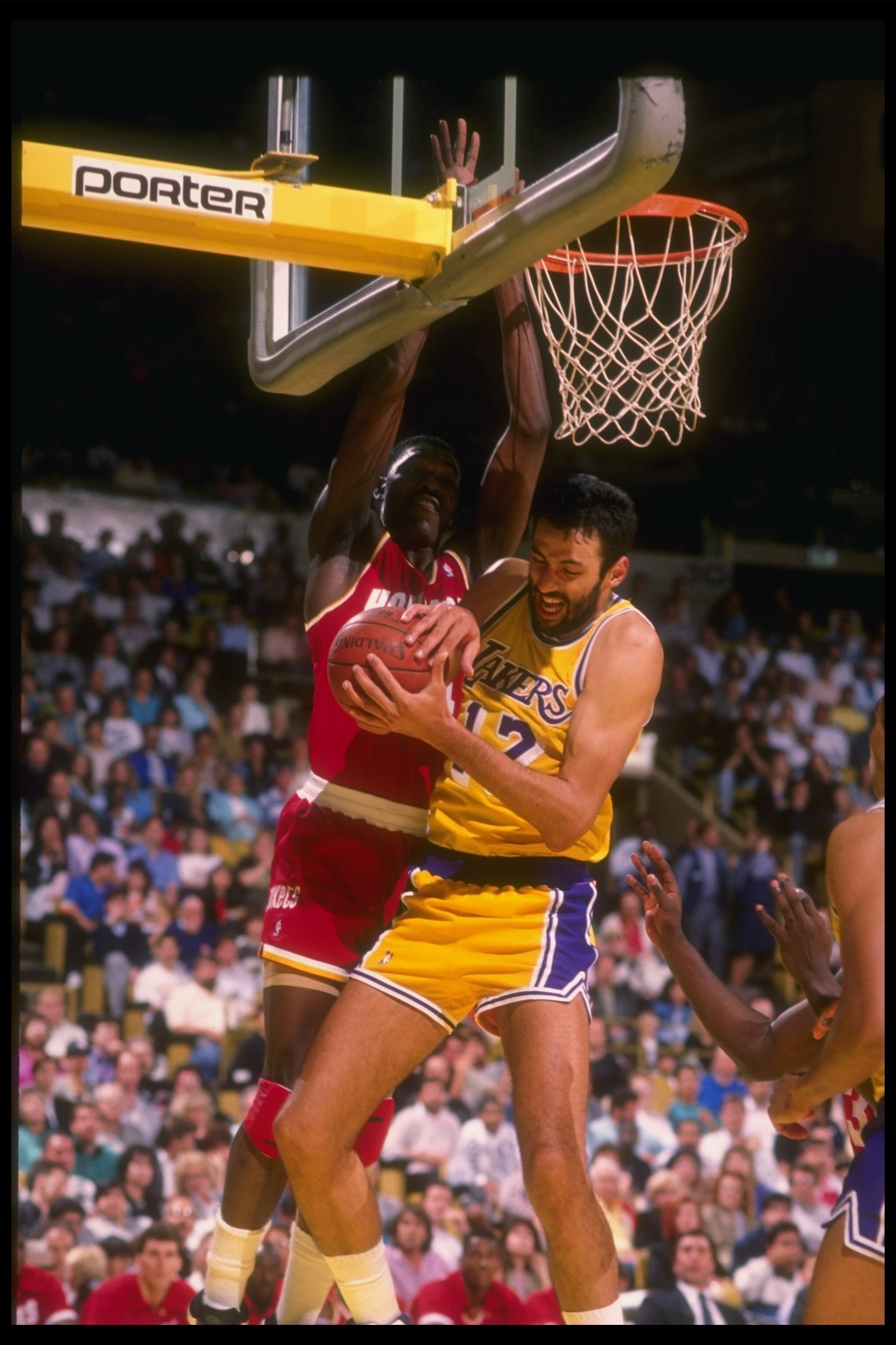 1989-1990:  Center Vlade Divac of the Los Angeles Lakers fights an center Hakeem Olajuwon of the Houston Rockets for the ball during a Lakers game versus the Rockets at the Great Western Forum in Inglewood, California. Mandatory Credit: Ken Levine  /Allsp