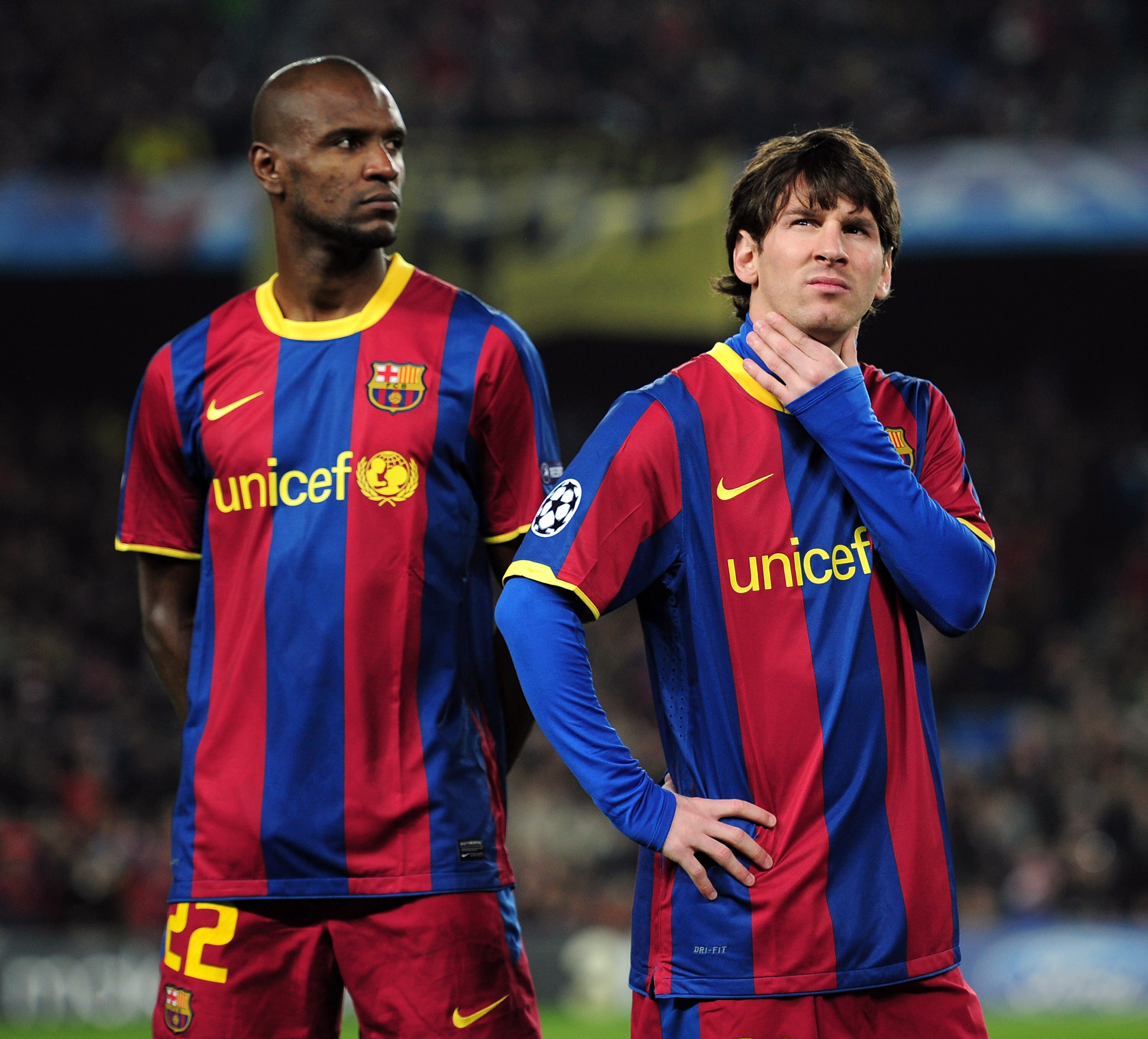 BARCELONA, SPAIN - MARCH 08:  Lionel Messi (R) and Eric Abidal of Barcelona wait for kick-off before the UEFA Champions League round of 16 second leg match between Barcelona and Arsenal at the Nou Camp Stadium on March 8, 2011 in Barcelona, Spain.  (Photo