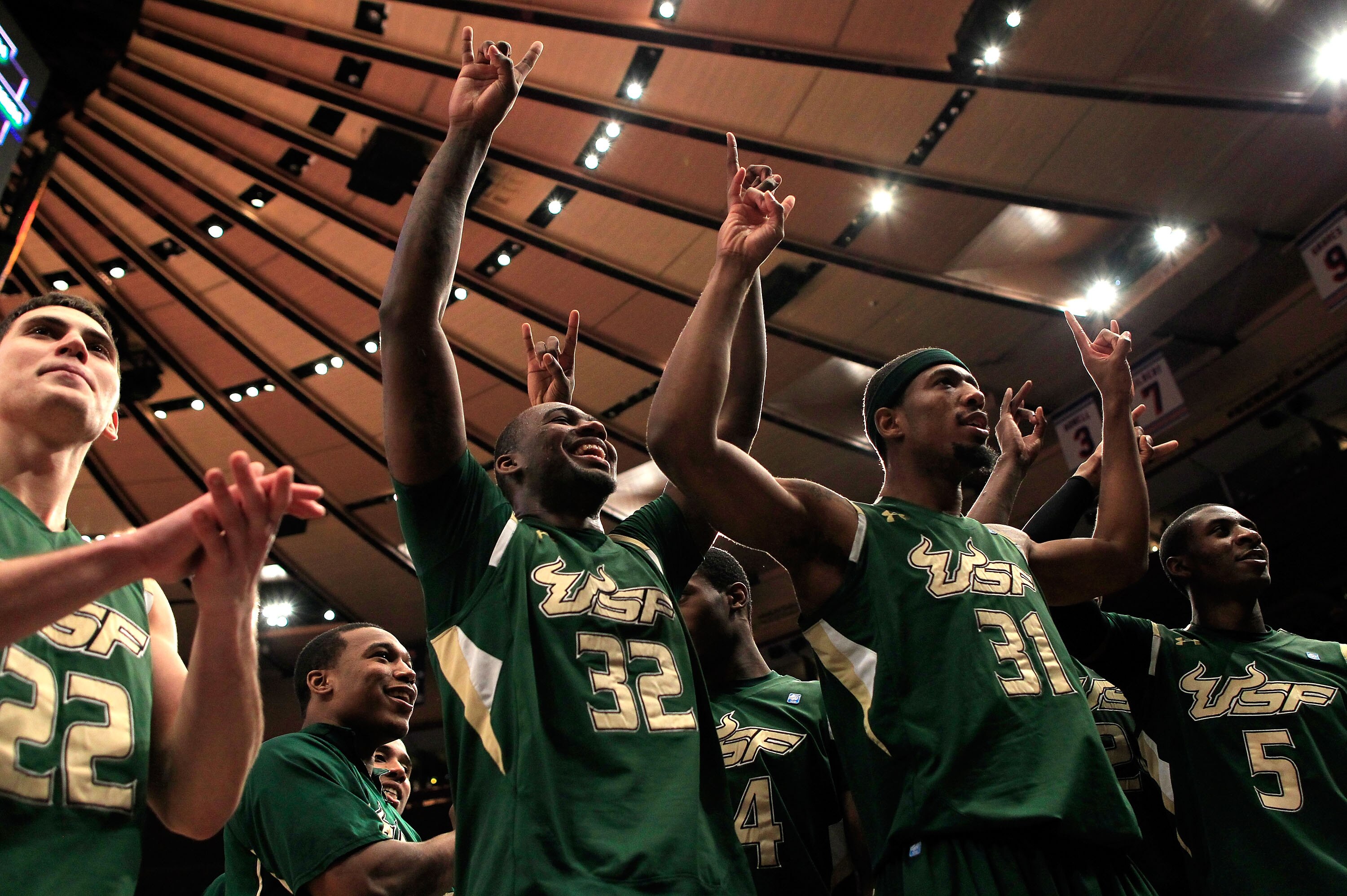 NEW YORK, NY - MARCH 08: Shaun Noriega #22, Toarlyn Fitzpatrick #32, Jarrid Famous #31 and Jawanza Poland #5 of the South Florida Bulls celebrate after defeating the Villanova Wildcats during the first round of the 2011 Big East Men's Basketball Tournamen