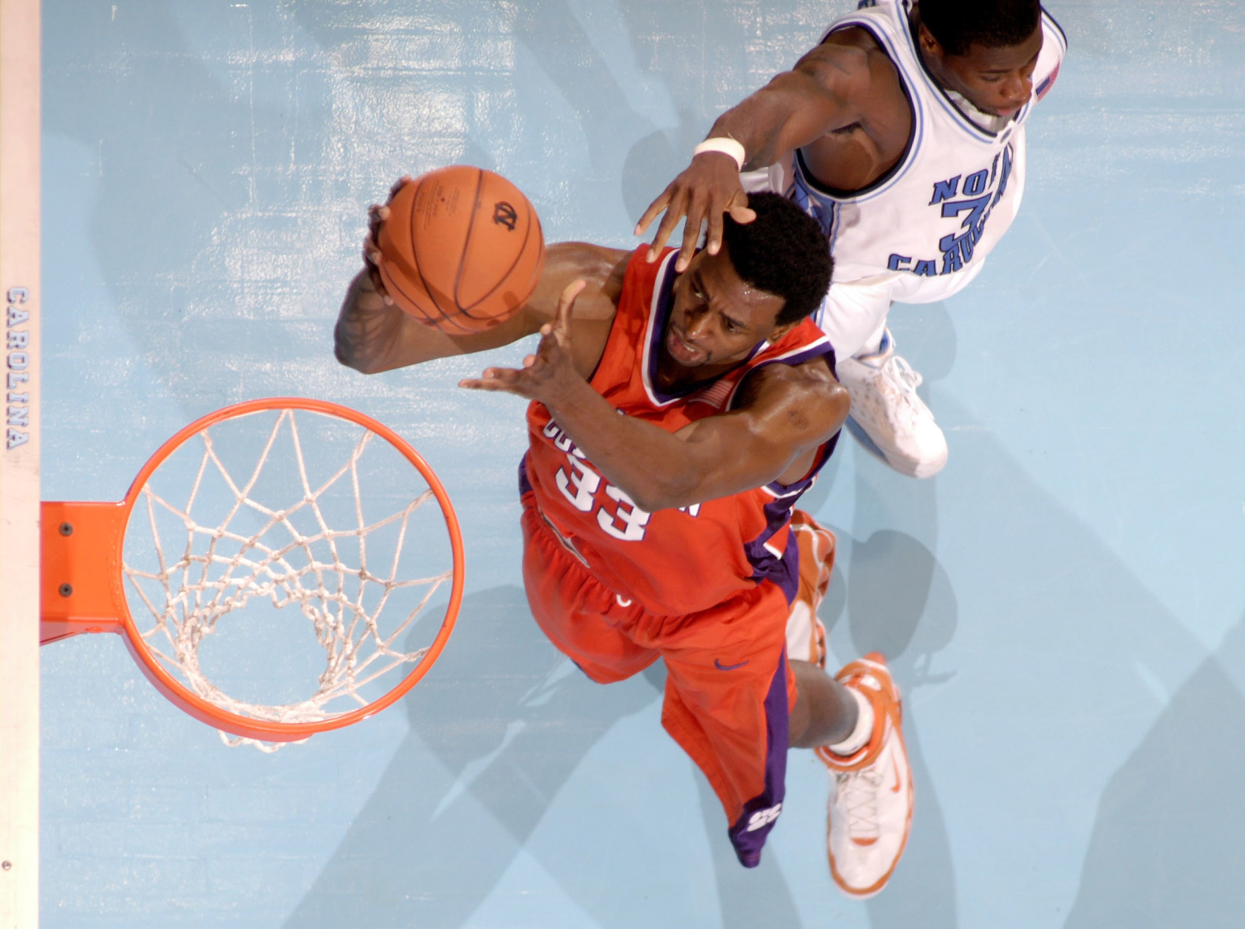 CHAPEL HILL, NC - FEBRUARY 4: Akin Akingbala #33 of the Clemson Tigers scores against David Noel #34 of the North Carolina Tar Heels during their game on February 4, 2006 at the Dean Smith Center in Chapel Hill, North Carolina. UNC defeated Clemson 76-61 CHAPEL HILL, NC - FEBRUARY 4: Akin Akingbala #33 of the Clemson Tigers scores against David Noel #34 of the North Carolina Tar Heels during their game on February 4, 2006 at the Dean Smith Center in Chapel Hill, North Carolina. UNC defeated Clemson 76-61