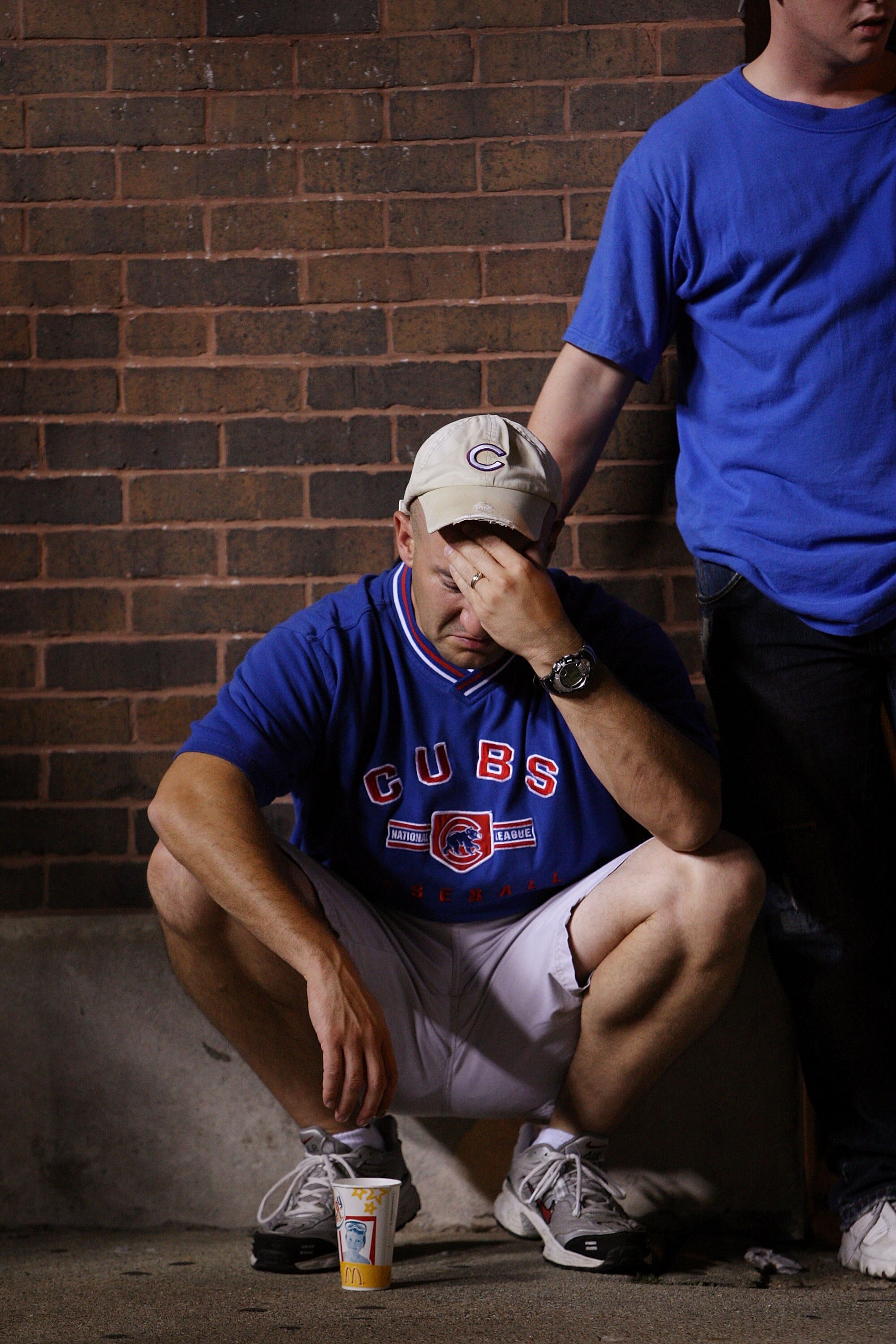CHICAGO - OCTOBER 6:  Pat Barron (L) is comforted by Justin Tesene as he reacts to the defeat of the Chicago Cubs by the Arizona Diamondbacks outside Wrigley Field following the National League Division Series October 6, 2007 in Chicago, Illinois. The Cub