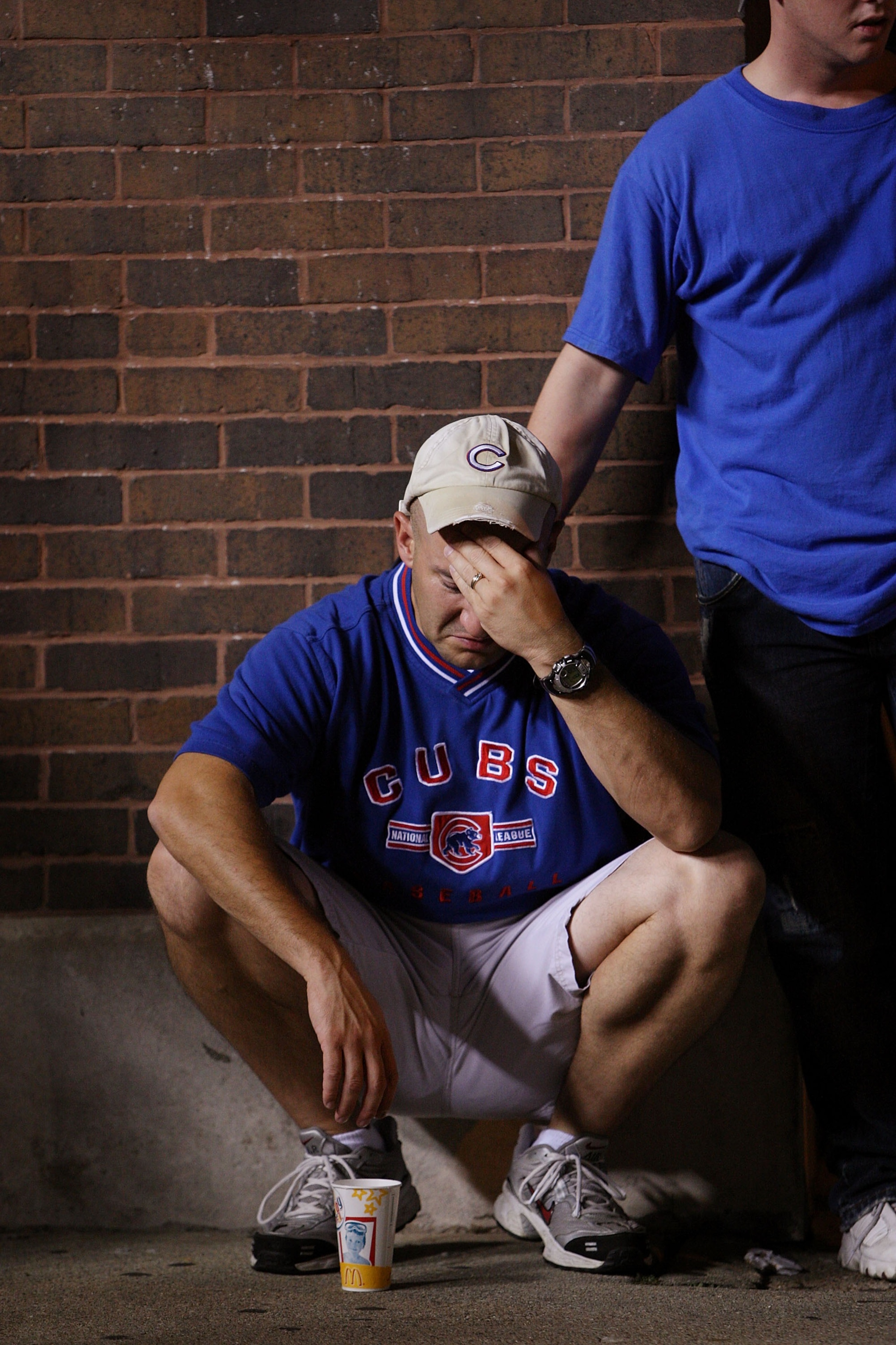 CHICAGO - OCTOBER 6:  Pat Barron (L) is comforted by Justin Tesene as he reacts to the defeat of the Chicago Cubs by the Arizona Diamondbacks outside Wrigley Field following the National League Division Series October 6, 2007 in Chicago, Illinois. The Cub