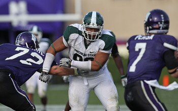 EVANSTON, IL - OCTOBER 23: Jerel Worthy #99 of the Michigan State Spartans moves past a block attempt by Brian Mulroe #72 of the Northwestern Wildcats with his sights set on Dan Persa #7 at Ryan Field on October 23, 2010 in Evanston, Illinois. Michigan St