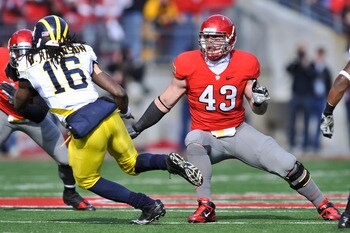 COLUMBUS, OH - NOVEMBER 27:  Nathan Williams #43 of the Ohio State Buckeyes defends against Denard Robinson #16 of the Michigan Wolverines at Ohio Stadium on November 27, 2010 in Columbus, Ohio.  (Photo by Jamie Sabau/Getty Images)