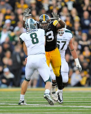IOWA CITY, IA - OCTOBER 30- Quarterback Kirk Cousins #8 of the Michigan State Spartans throws under pressure from defensive lineman Mike Daniels #93 of the University of Iowa Hawkeyes during the second half of play at Kinnick Stadium on October 30, 2010 i
