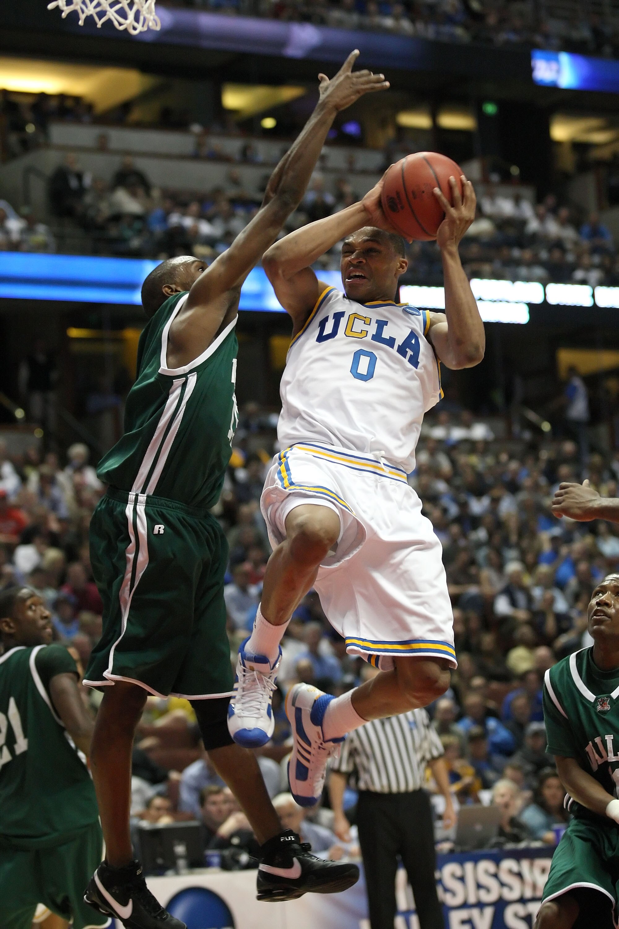 \ANAHEIM, CA - MARCH 20:  Russell Westbrook #0 of the UCLA Bruins drives to bask over the defense of Chris Watson #15 of the Mississippi Valley State Delta Devils during the West Region first round of the NCAA Basketball Tournament at the Honda Center on