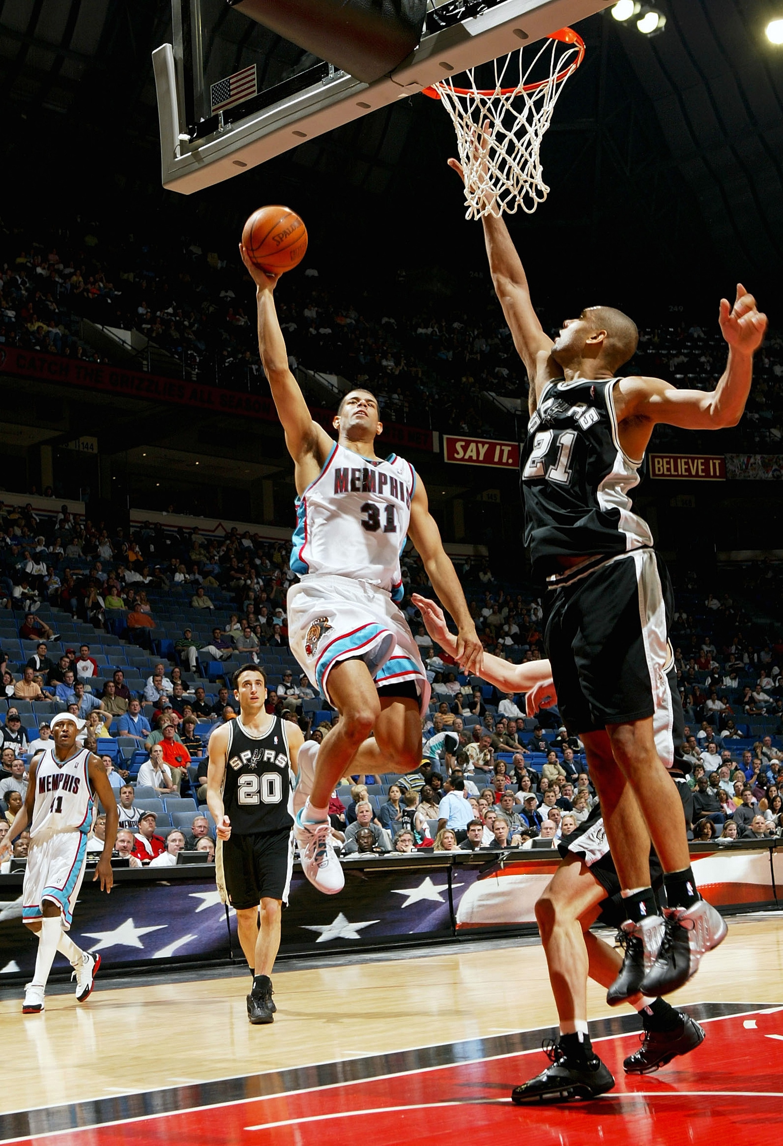 MEMPHIS, TN - APRIL 25:  Shane Battier #31 of the Memphis Grizzlies drives to the basket against Tim Duncan #21 of the San Antonio Spurs during Game four of Western Conference Quarterfinals of the 2004 NBA Playoffs April 25, 2004 at The Pyramid in Memphis
