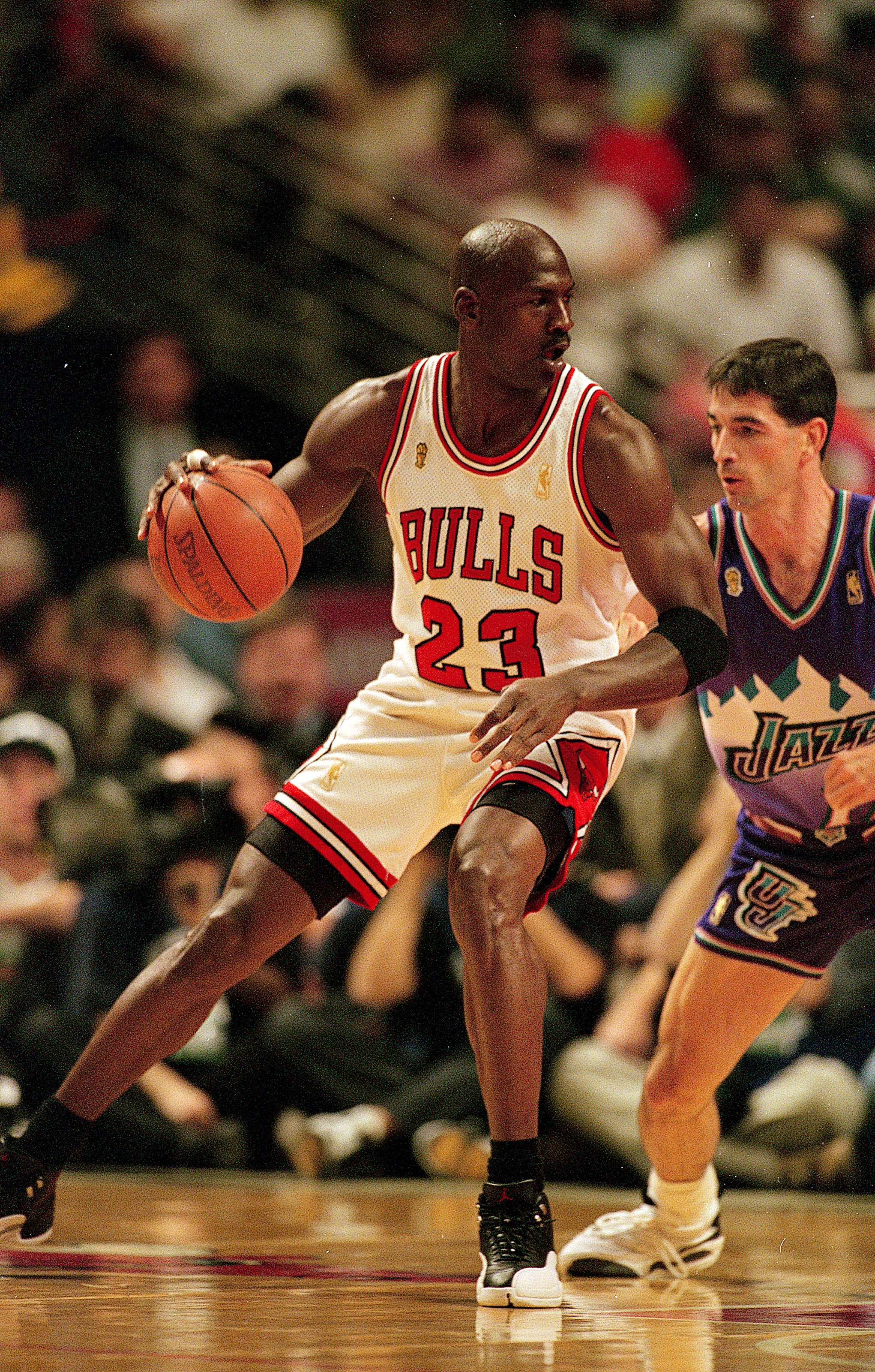 I3 Jun 1997:  Michael Jordan #23 of the Chicago Bulls dribbles the ball as he is guarded by John Stockton #12 of the Utah Jazz during game six of the NBA Final at the United Center in Chicago, Illinois. The Bulls defeated the Jazz 90-86..   Mandatory Cred