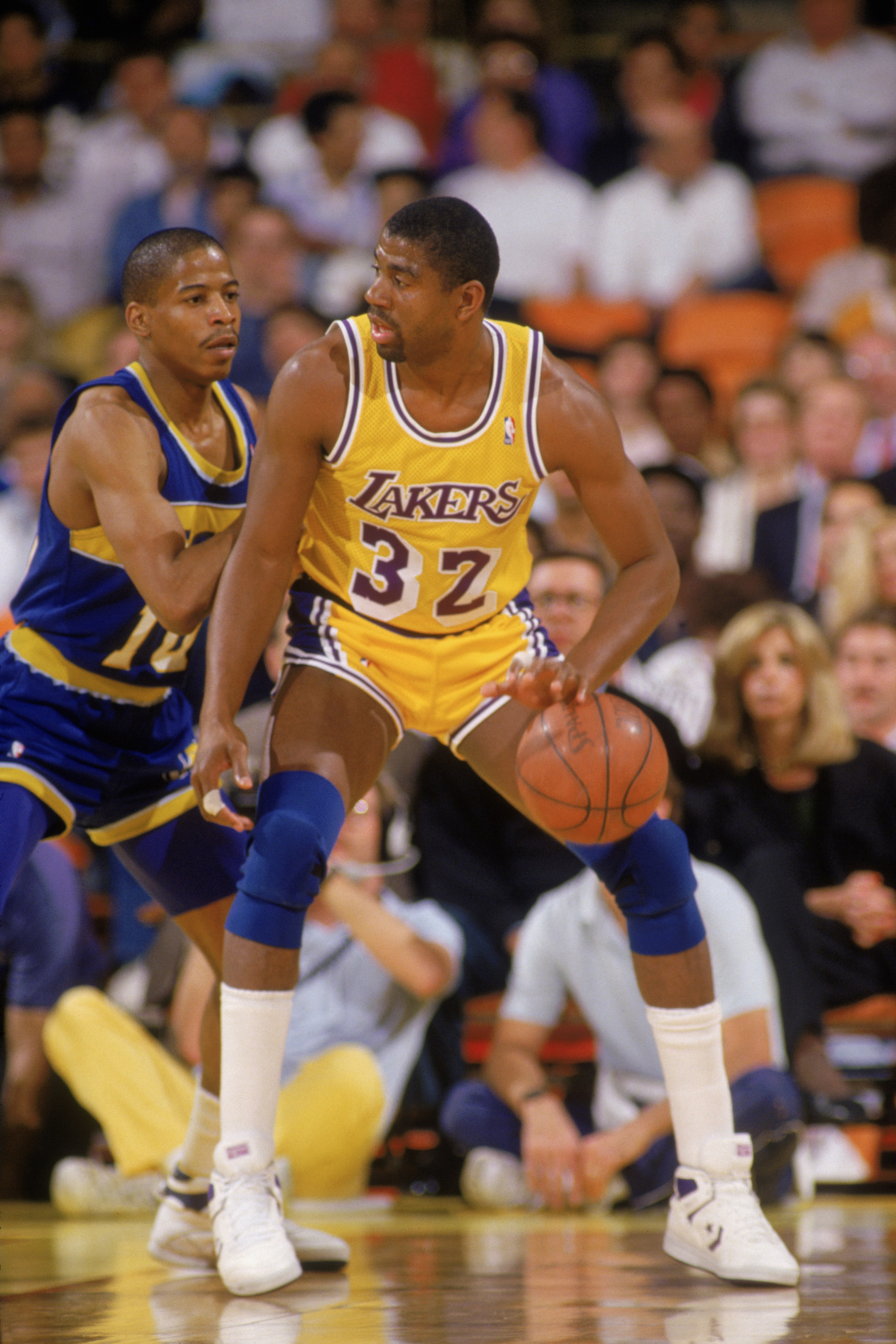 LOS ANGELES - 1987:  Magic Johnson #32 of the Los Angeles Lakers dribbles the ball in the post during an NBA game against the Golden State Warriors at the Great Western Forum in Los Angeles, California in 1987. (Photo by: Stephen Dunn/Getty Images)