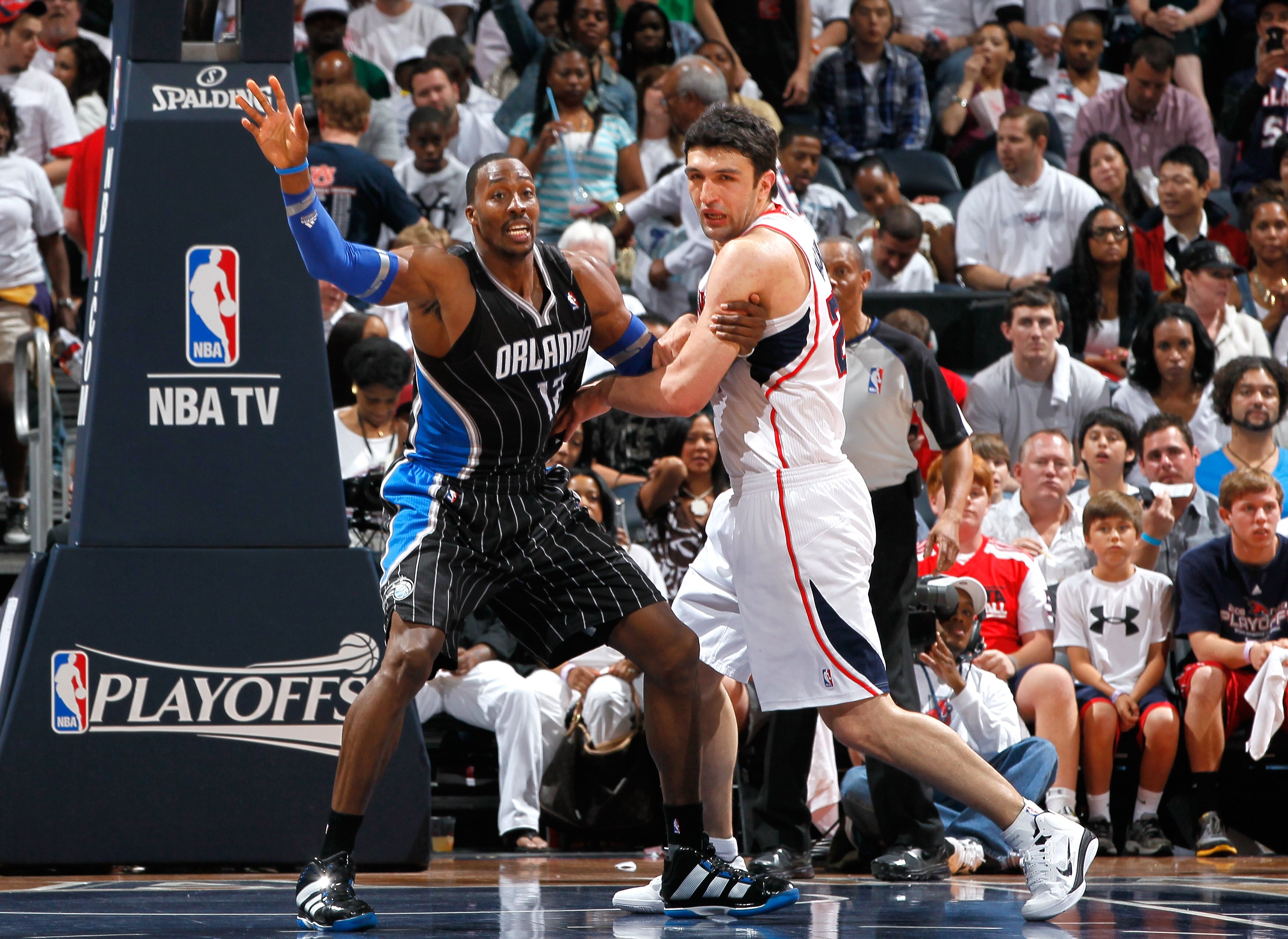 ATLANTA, GA - APRIL 28:  Dwight Howard #12 of the Orlando Magic battles for position in the paint against Zaza Pachulia #27 of the Atlanta Hawks during Game Six of the Eastern Conference Quarterfinals in the 2011 NBA Playoffs at Philips Arena on April 28,