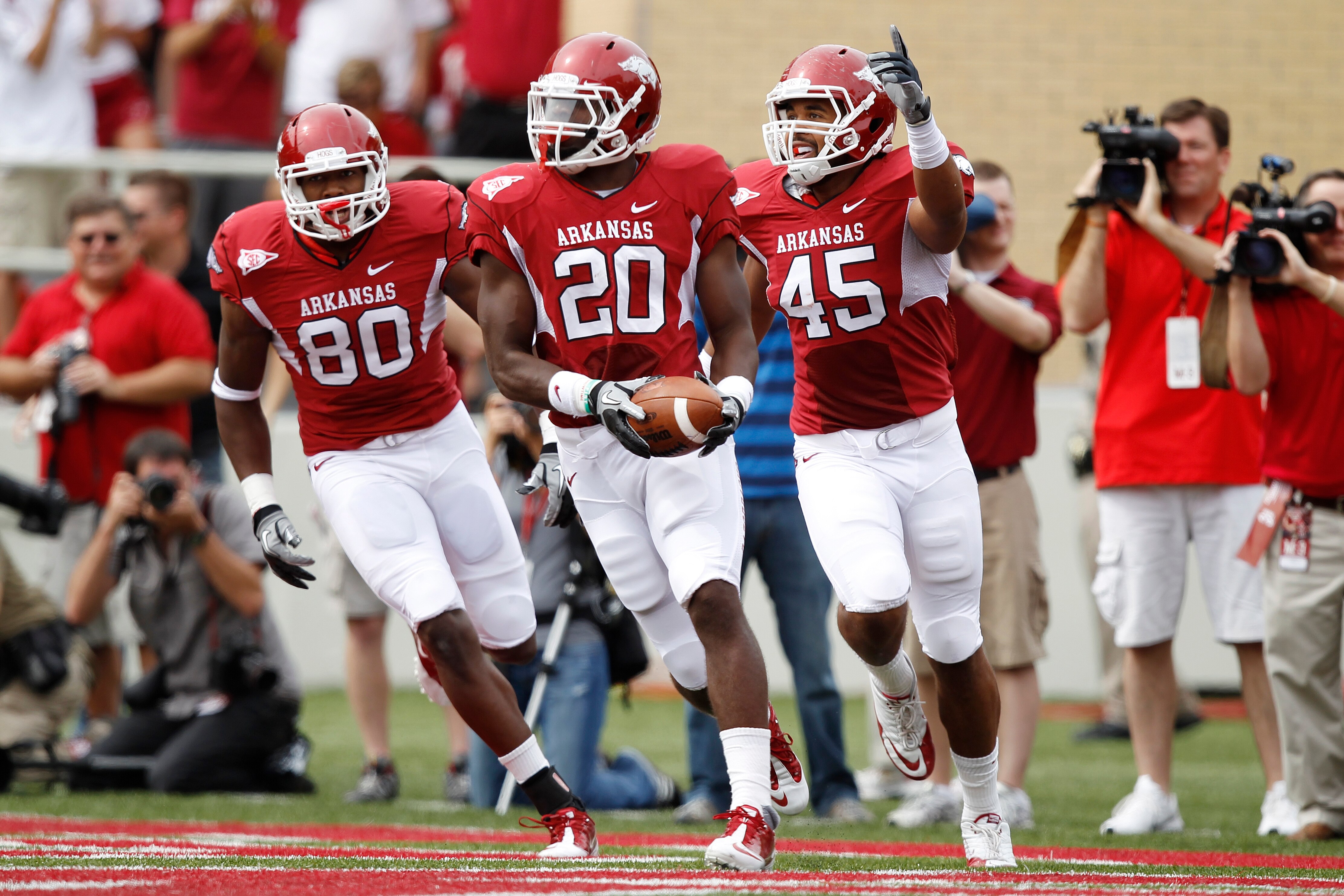 FAYETTEVILLE - SEPTEMBER 25: Ronnie Wingo Jr. #20 of the Arkansas Razorbacks celebrates with teammates D.J. Williams #45 and Chris Gragg #80 after a first half touchdown against the Alabama Crimson Tide at Donald W. Reynolds Razorback Stadium on September