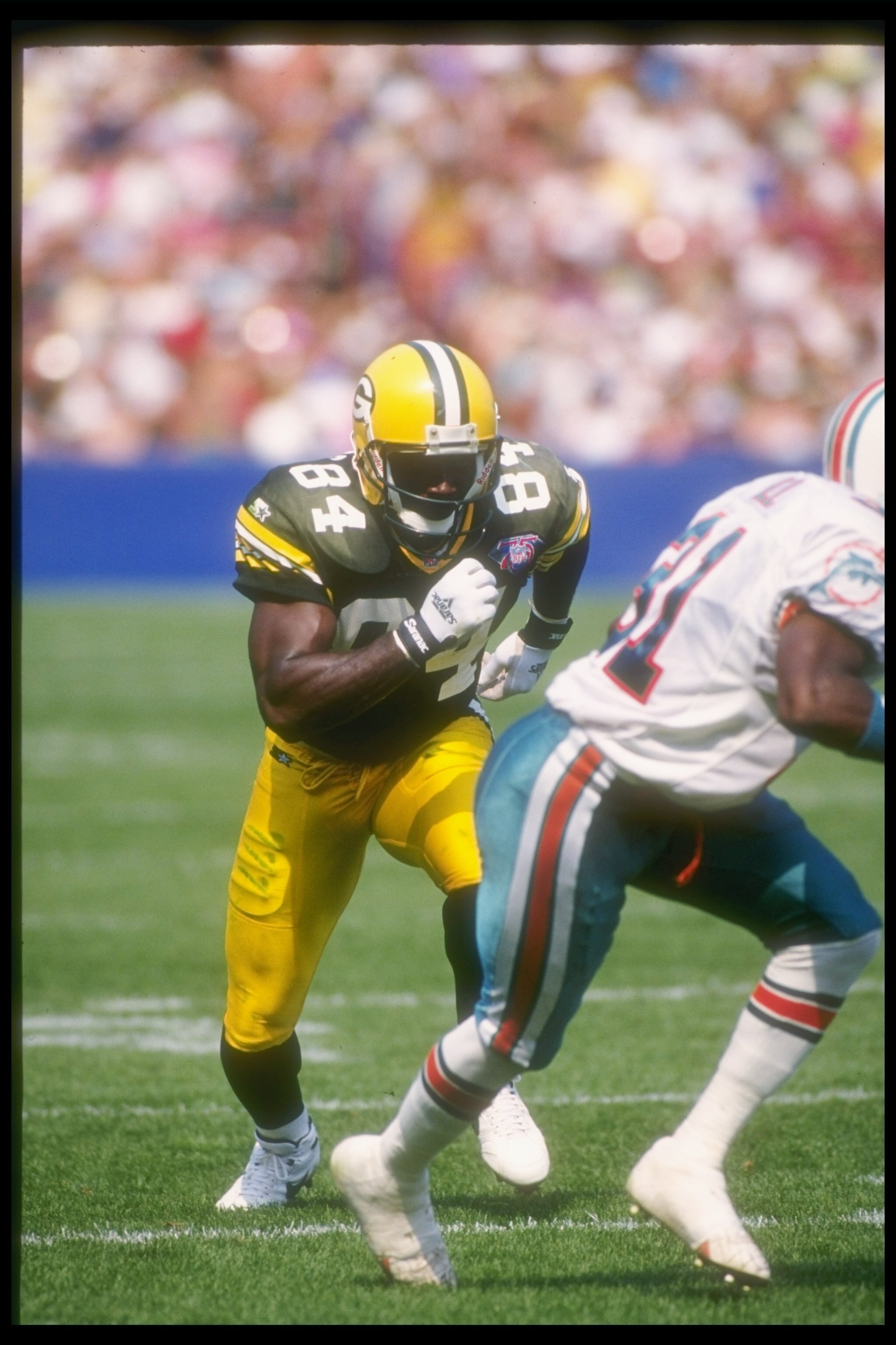 11 Sep 1994:  Wide receiver Sterling Sharpe of the Green Bay Packers  (left) runs a pass pattern during a game against the Miami Dolphins at Milwaukee County Stadium in Milwaukee, Wisconsin.  The Dolphins won the game, 24-14. Mandatory Credit: Jonathan Da