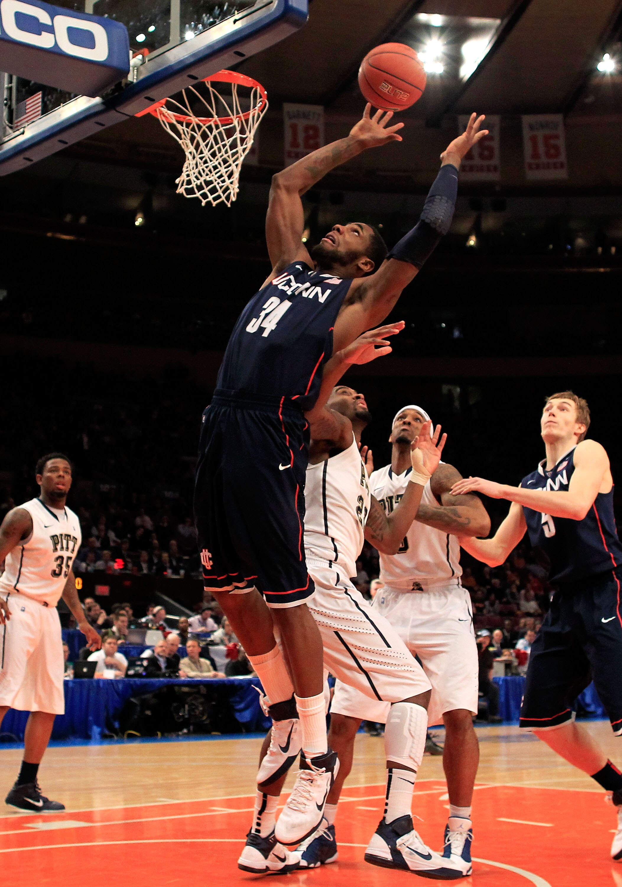NEW YORK, NY - MARCH 10: Alex Oriakhi #34 of the Connecticut Huskies drives to the basket against Brad Wanamaker #22 of the Pittsburgh Panthers during the quarterfinals of the 2011 Big East Men's Basketball Tournament presented by American Eagle Outfitter
