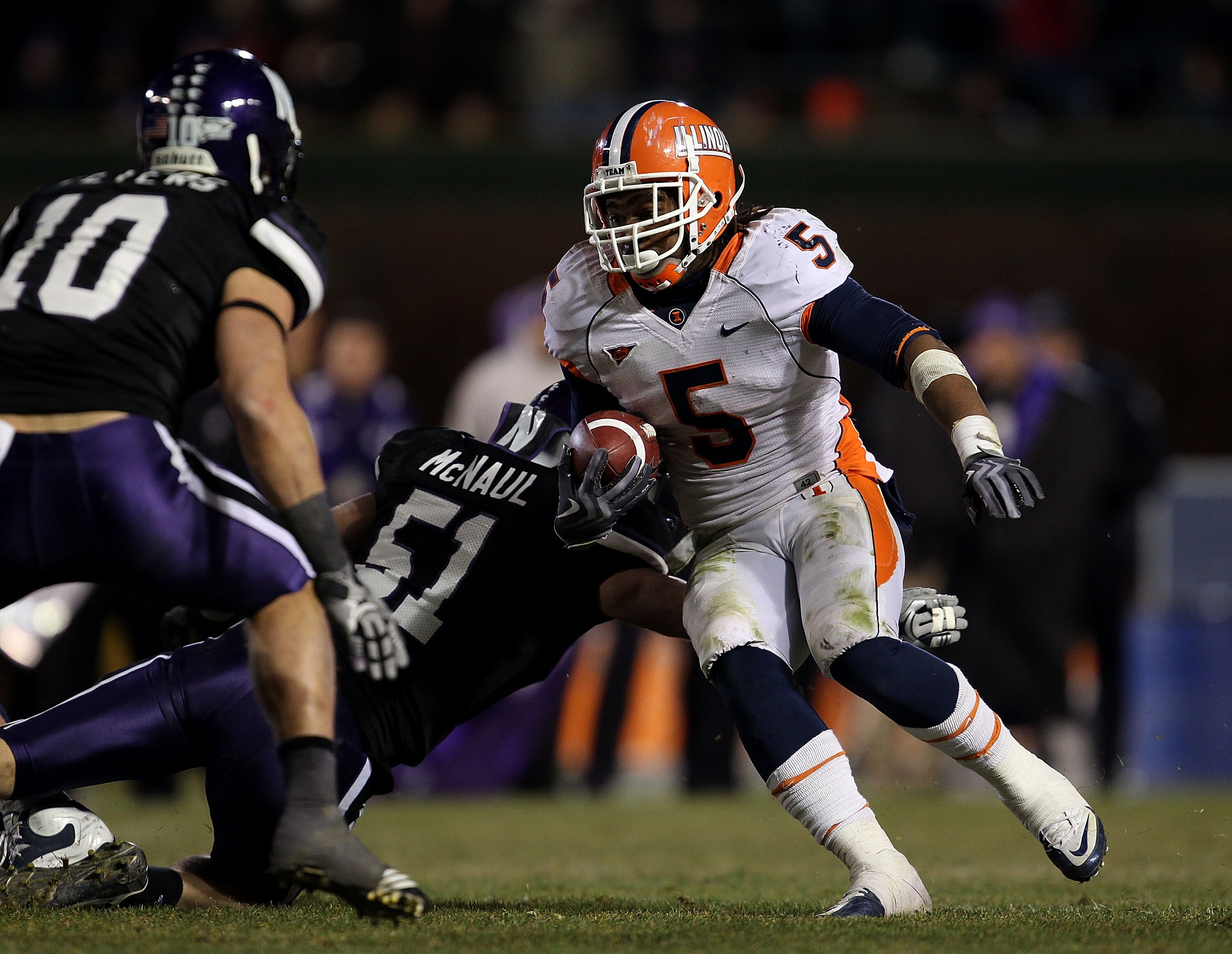 CHICAGO - NOVEMBER 20: Mikel Leshoure #5 of the Illinois Fighting Illini runs past Bryce McNaul #51 of the Northwestern Wildcats and towards Brian Peters #10 on his way to a 339 yard rushing performance during a game played at Wrigley Field on November 20 CHICAGO - NOVEMBER 20: Mikel Leshoure #5 of the Illinois Fighting Illini runs past Bryce McNaul #51 of the Northwestern Wildcats and towards Brian Peters #10 on his way to a 339 yard rushing performance during a game played at Wrigley Field on November 20