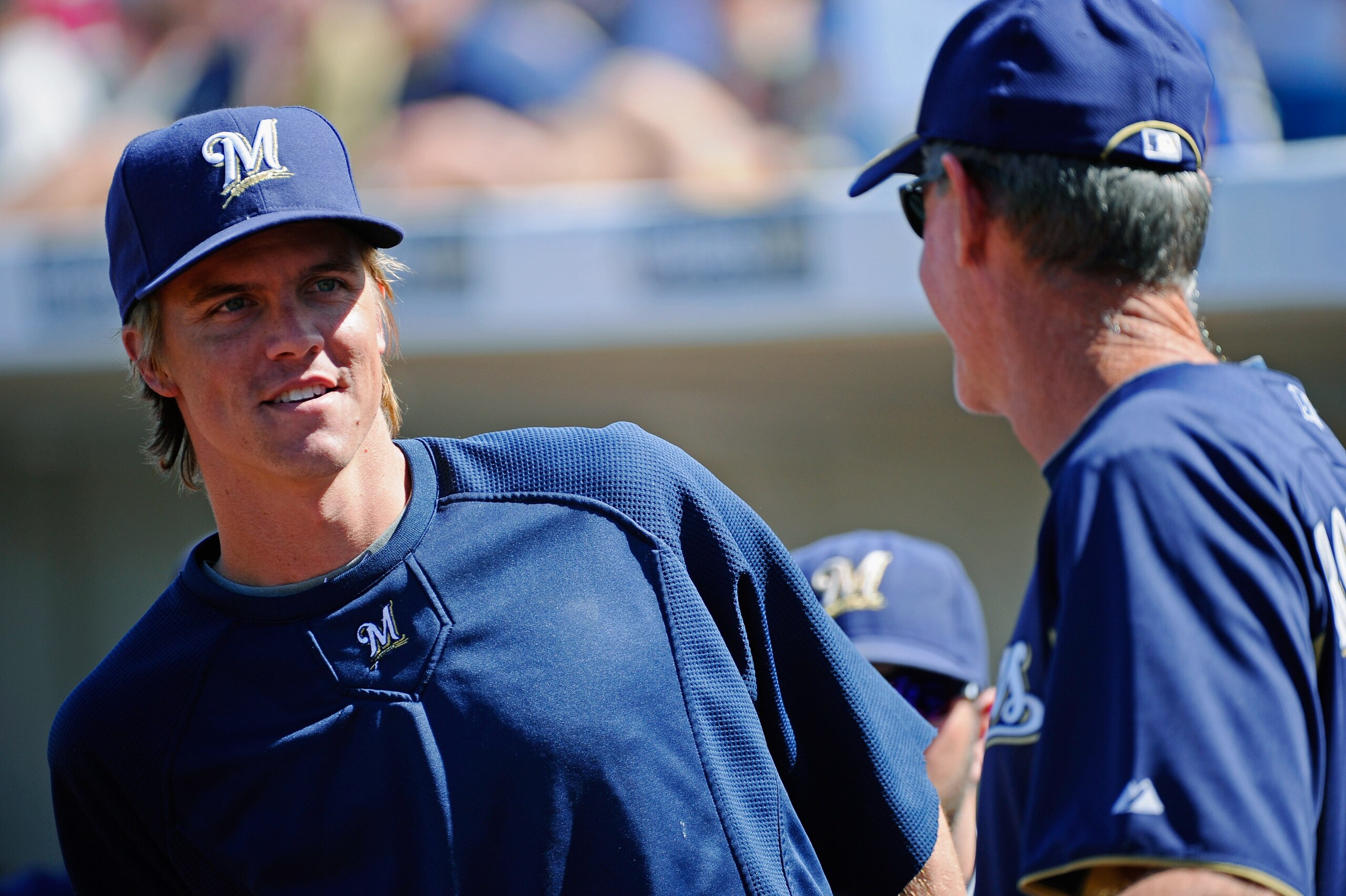 PHOENIX, AZ - MARCH 10:  Pitcher Zack Greinke #13  of the Milwaukee Brewers  speaks with manager Ron Roenicke during the spring training baseball game against Colorado Rockies at Maryvale Baseball Park on March 10, 2011 in Phoenix, Arizona.  (Photo by Kev