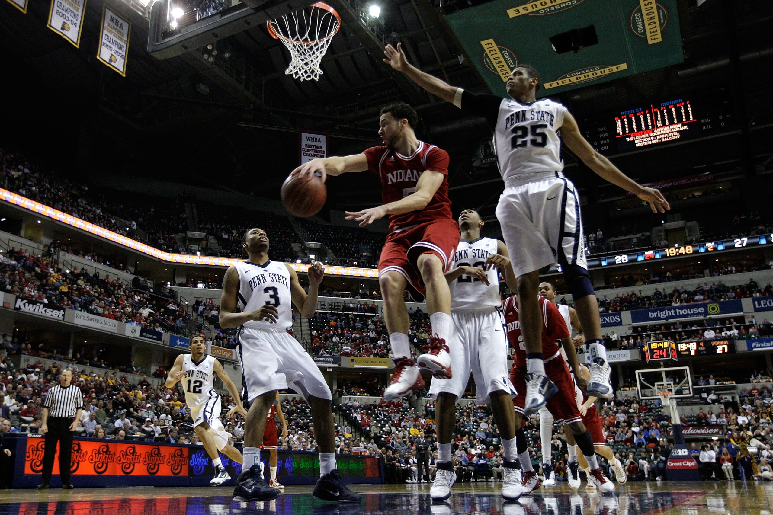INDIANAPOLIS, IN - MARCH 10:  Jeremiah Rivers #5 of the Indiana Hoosiers passes the ball against Jermaine Marshall #3 and Jeff Brooks #25 of the Penn State Nittany Lions during the first round of the 2011 Big Ten Men's Basketball Tournament at Conseco Fie