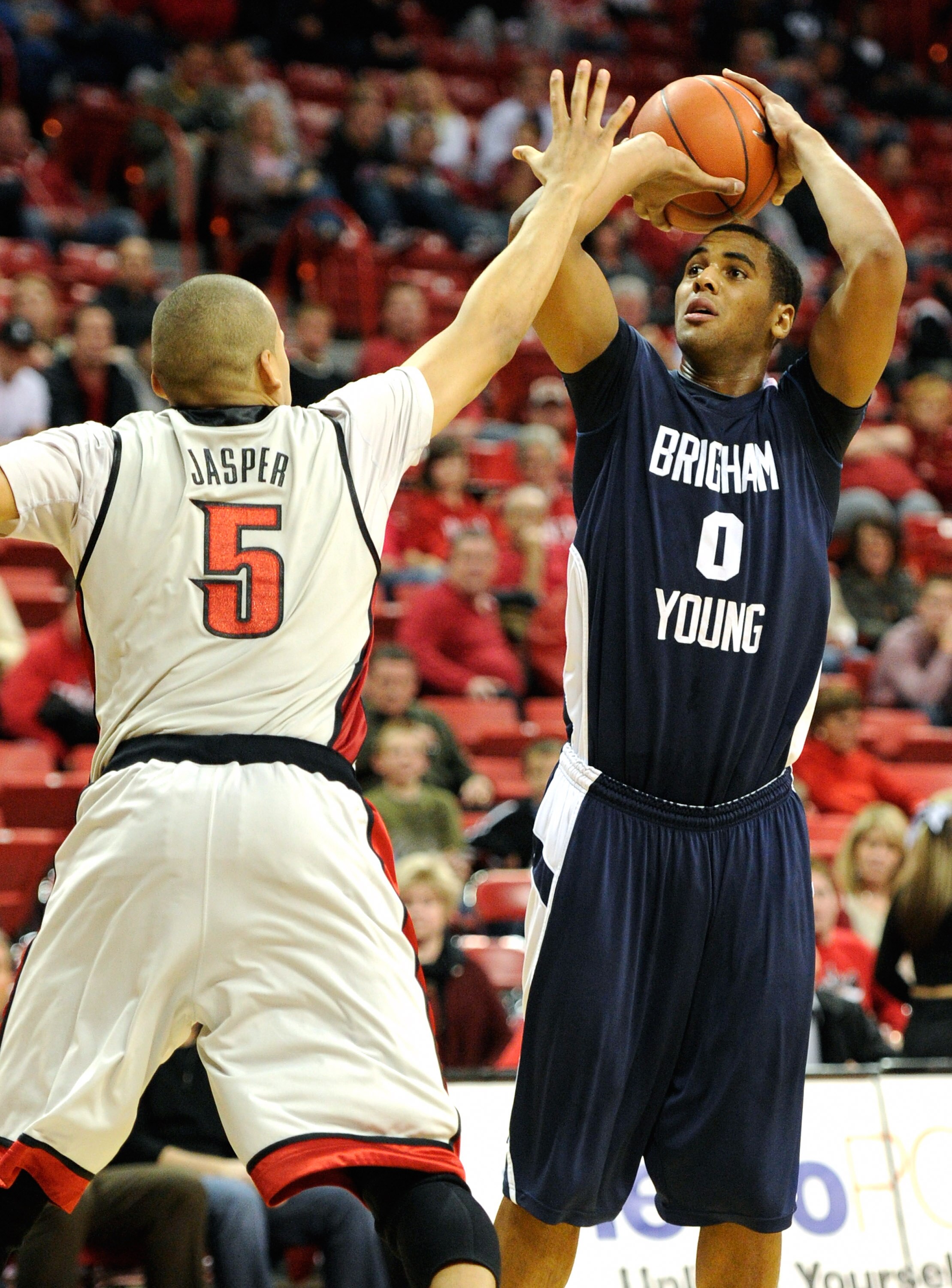 LAS VEGAS, NV - JANUARY 05:  Brandon Davies #0 of the Brigham Young University Cougars shoots against Derrick Jasper #5 of the UNLV Rebels during their game at the Thomas & Mack Center January 5, 2011 in Las Vegas, Nevada. BYU won 89-77.  (Photo by Ethan