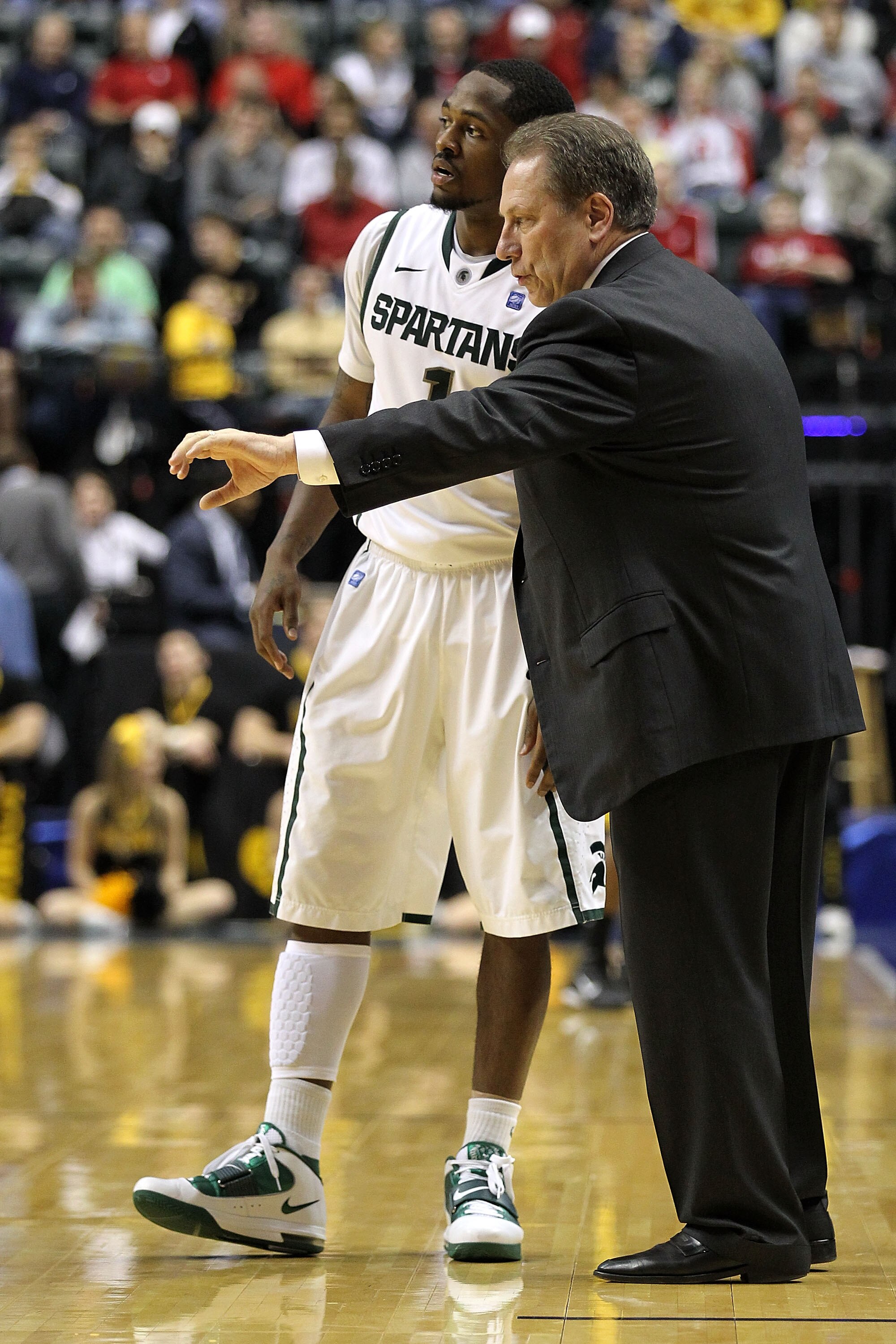 INDIANAPOLIS, IN - MARCH 10:  Head coach Tom Izzo and Kalin Lucas #1 of the Michigan State Spartans talk on the sideline against the Iowa Hawkeyes during the first round of the 2011 Big Ten Men's Basketball Tournament at Conseco Fieldhouse on March 10, 20