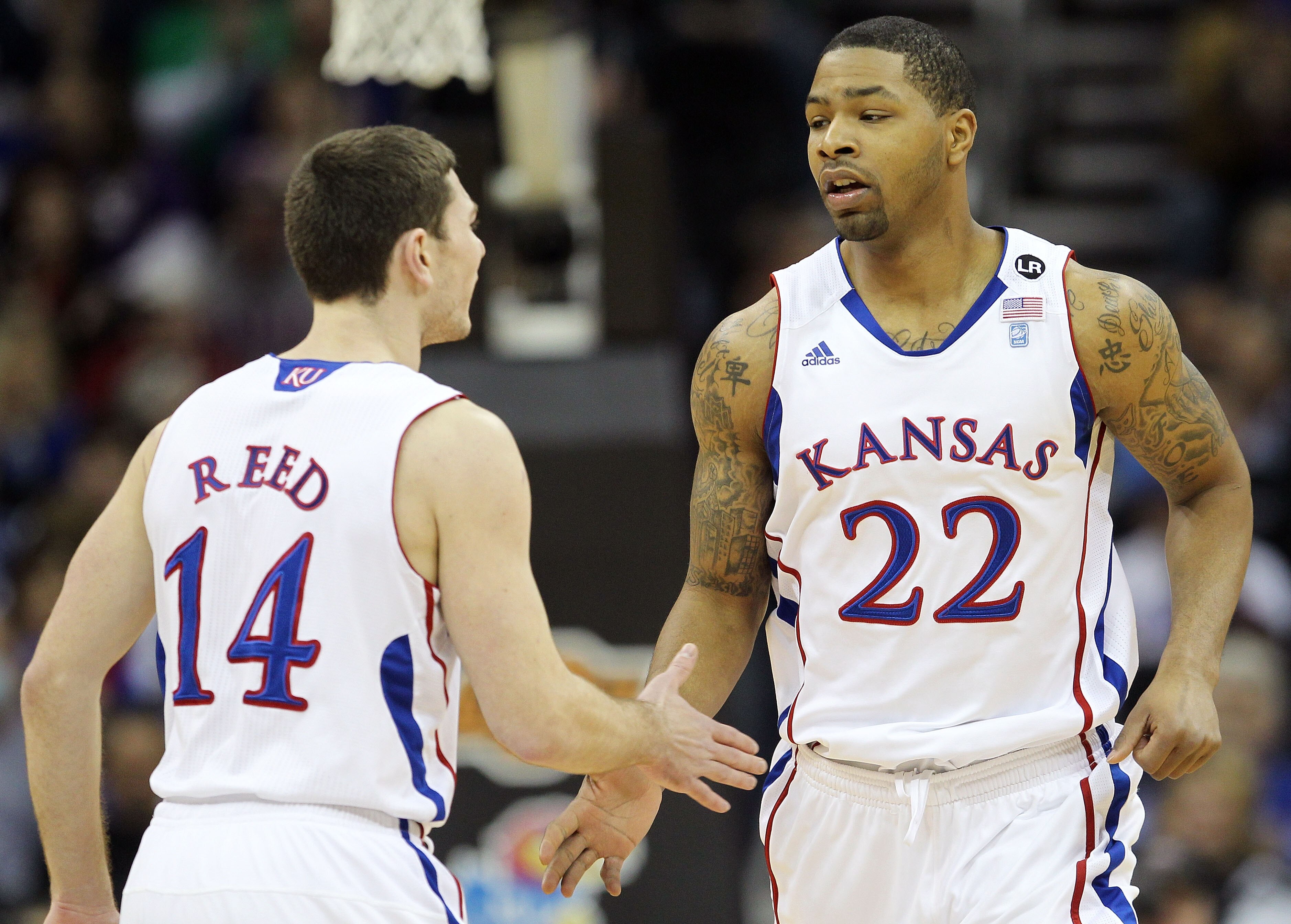 KANSAS CITY, MO - MARCH 10:  Tyrel Reed #14 and Marcus Morris #22 of the Kansas Jayhawks react after a play against the Oklahoma State Cowboys during their quarterfinal game in the 2011 Phillips 66 Big 12 Men's Basketball Tournament at Sprint Center on Ma