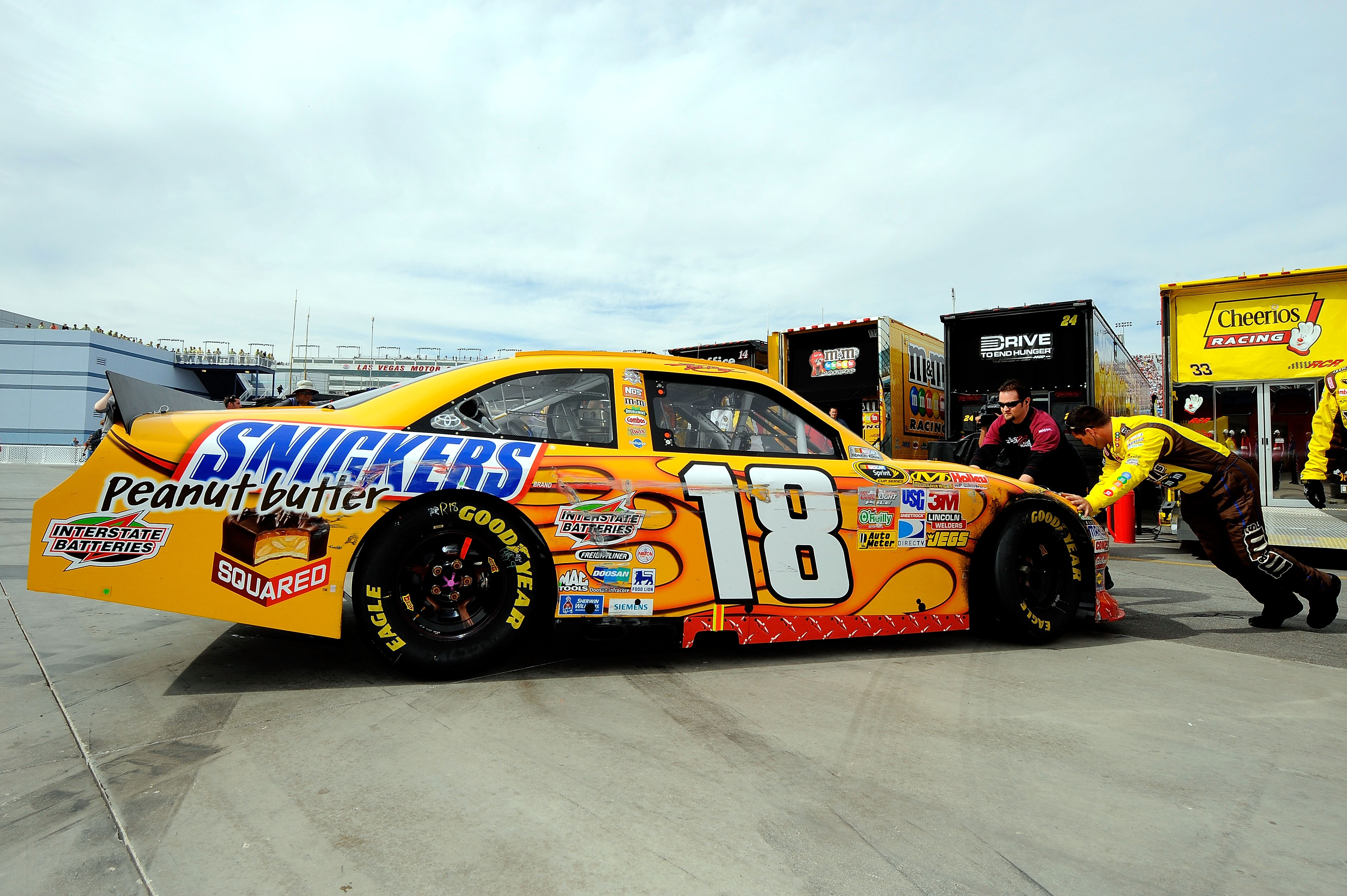 LAS VEGAS, NV - MARCH 06:  Crew members push the #18 Snickers Peanut Butter Squared Toyota, driven by Kyle Busch, through the garage area after an incident in the NASCAR Sprint Cup Series Kobalt Tools 400 at Las Vegas Motor Speedway on March 6, 2011 in La