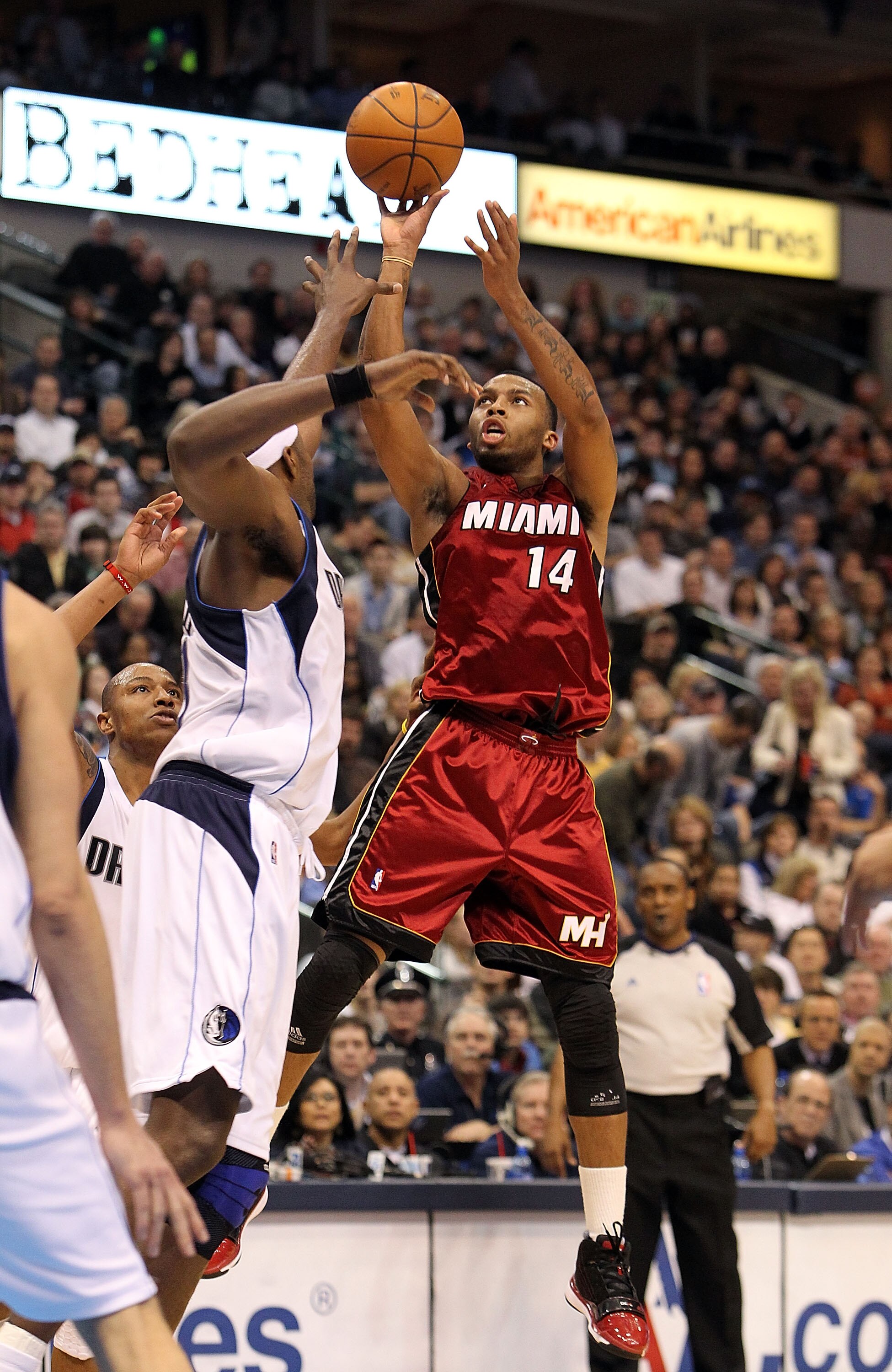 DALLAS - FEBRUARY 20:  Guard Daequan Cook #14 of the Miami Heat takes a shot against Brendan Haywood #33 of the Dallas Mavericks on February 20, 2010 at American Airlines Center in Dallas, Texas.  NOTE TO USER: User expressly acknowledges and agrees that,