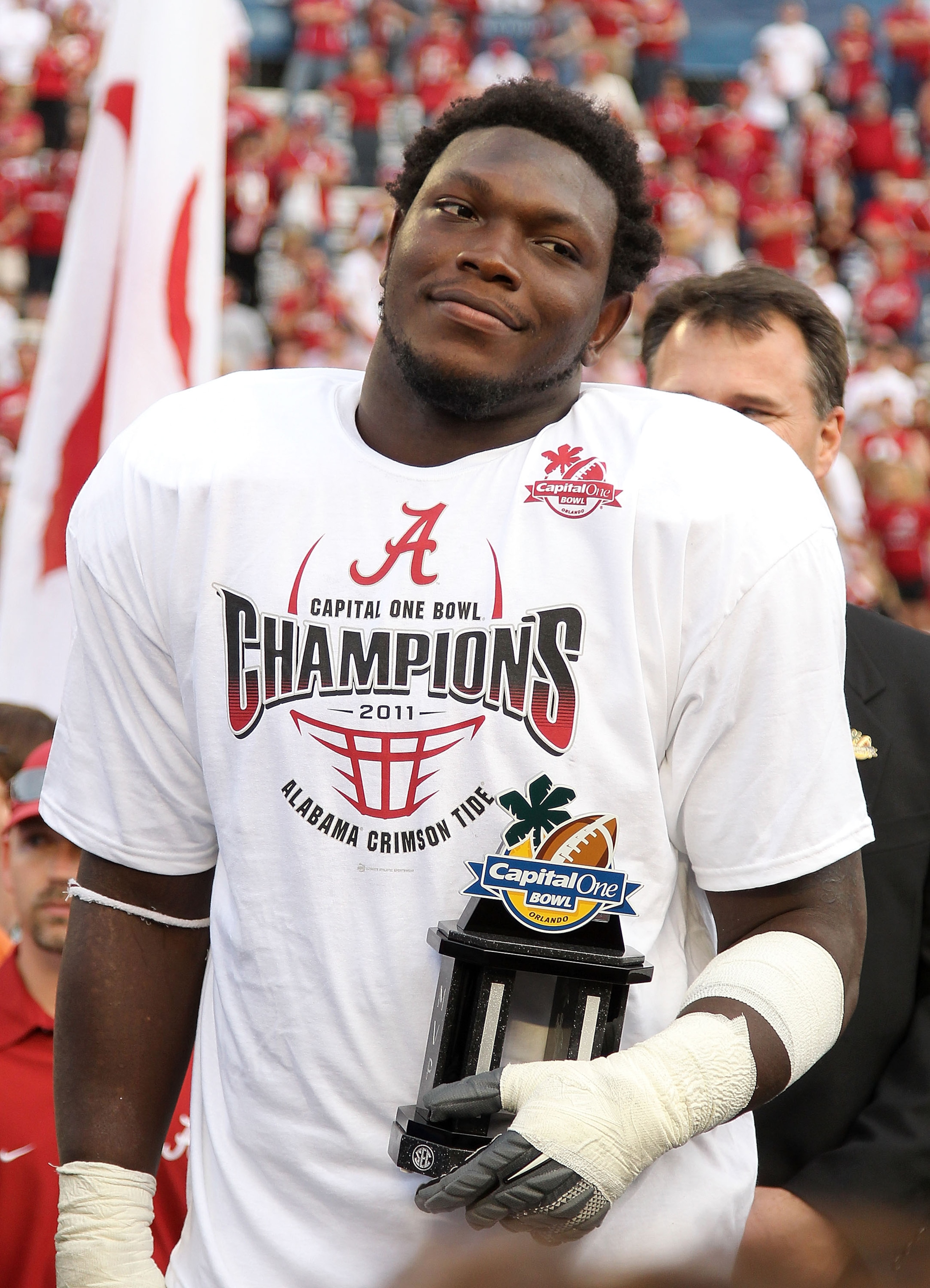 ORLANDO, FL - JANUARY 01: Courtney Upshaw #41 of the Alabama Crimson Tide accepts the MVP award after winning the Capitol One Bowl against the Michigan State Spartans at the Florida Citrus Bowl on January 1, 2011 in Orlando, Florida. (Photo by Mike Ehrm ORLANDO, FL - JANUARY 01: Courtney Upshaw #41 of the Alabama Crimson Tide accepts the MVP award after winning the Capitol One Bowl against the Michigan State Spartans at the Florida Citrus Bowl on January 1, 2011 in Orlando, Florida. (Photo by Mike Ehrm
