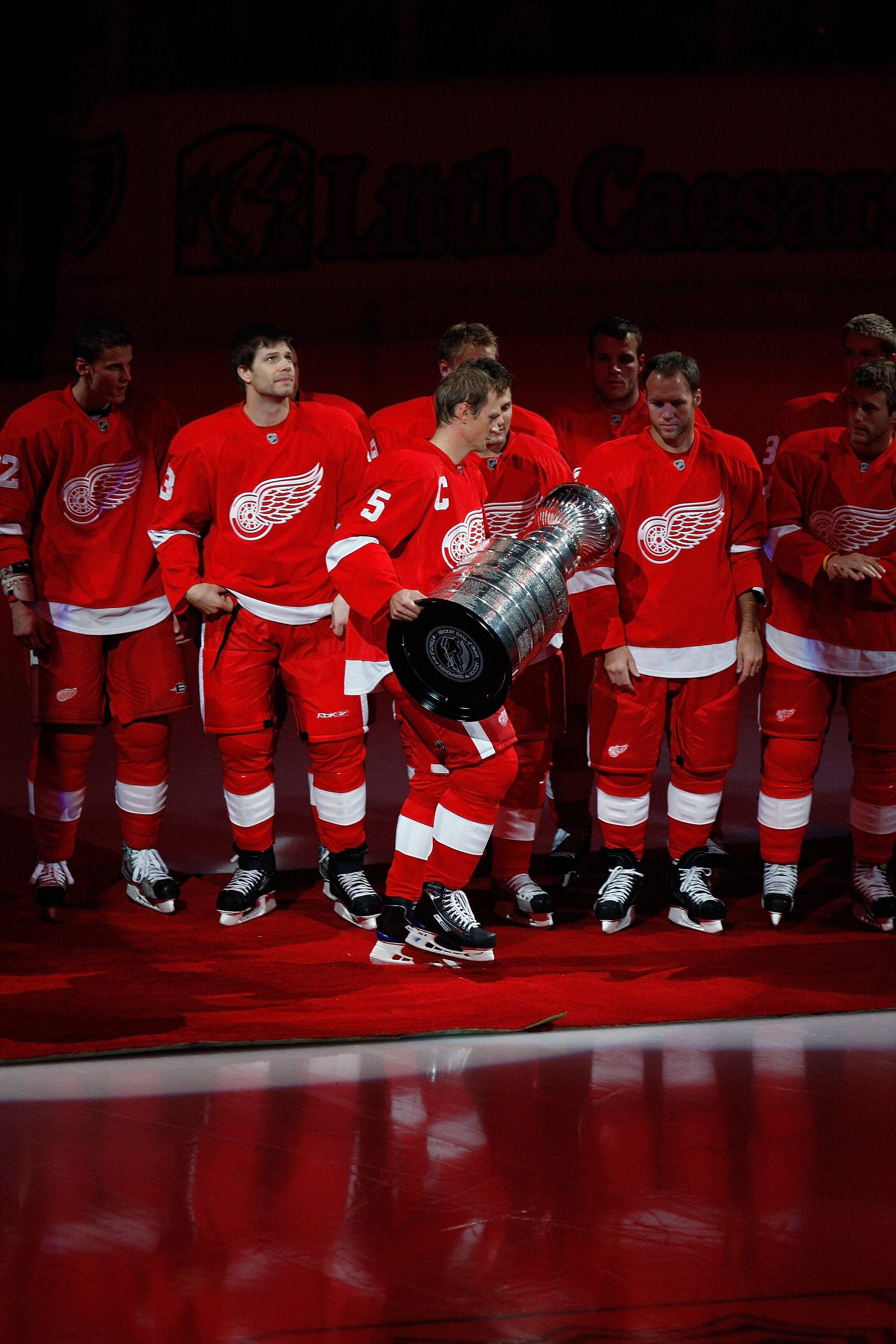 DETROIT - OCTOBER 9:  Captain Nicklas Lidstrom #5 of the Detroit Red Wings walks out to center ice with the Stanley Cup prior to the raising of their 2007-2008 Stanley Cup banner before their game against the Toronto Maple Leafs on October 9, 2008 at Joe
