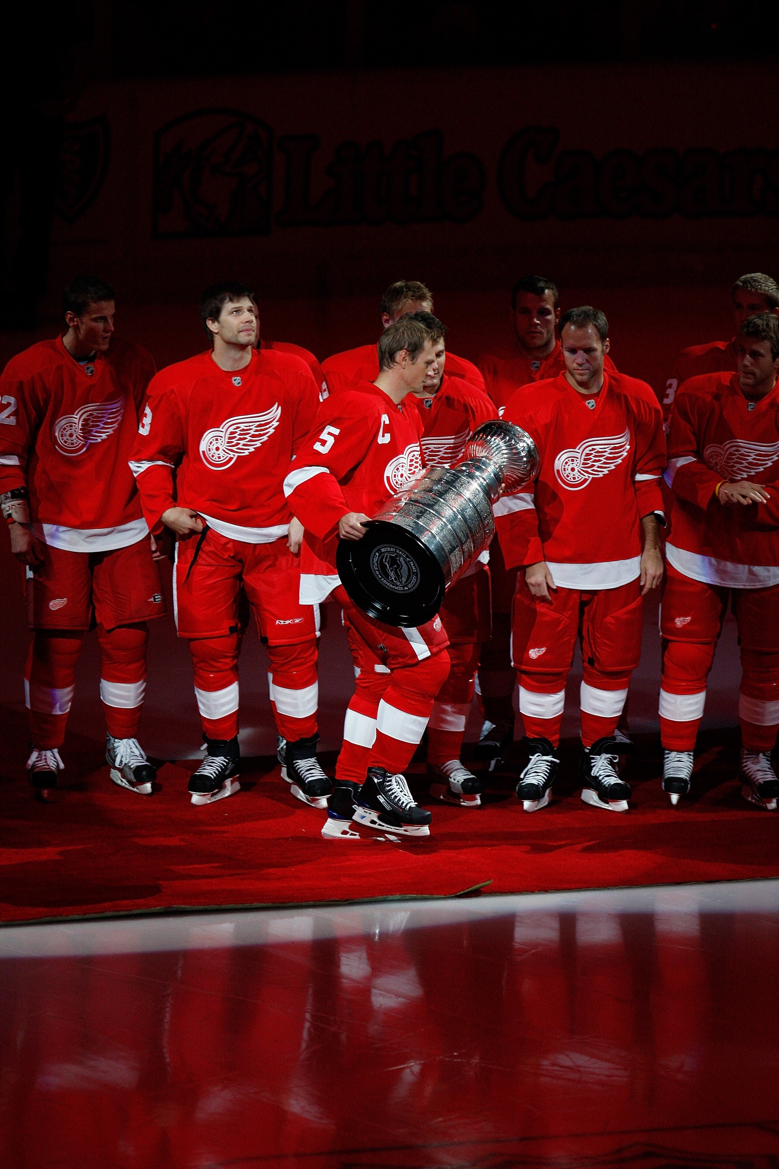 DETROIT - OCTOBER 9:  Captain Nicklas Lidstrom #5 of the Detroit Red Wings walks out to center ice with the Stanley Cup prior to the raising of their 2007-2008 Stanley Cup banner before their game against the Toronto Maple Leafs on October 9, 2008 at Joe
