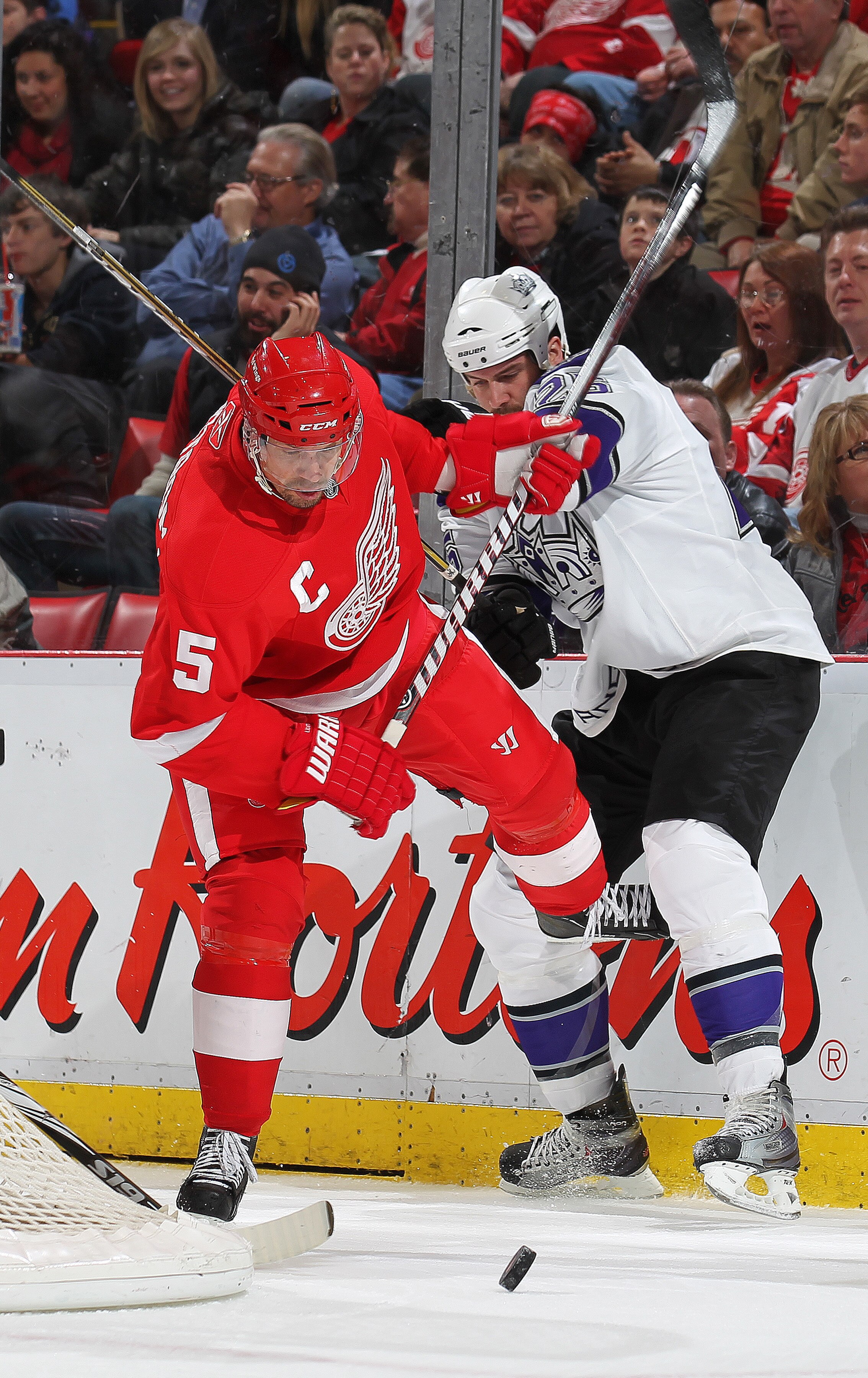 DETROIT, MI - MARCH 9:  Dustin Penner #25 of the Los Angeles Kings is knocked off the puck by Nicklas Lidstrom #5 of the Detroit Red Wings in a game on March 9, 2011 at the Joe Louis Arena in Detroit, Michigan. (Photo by Claus Andersen/Getty Images)