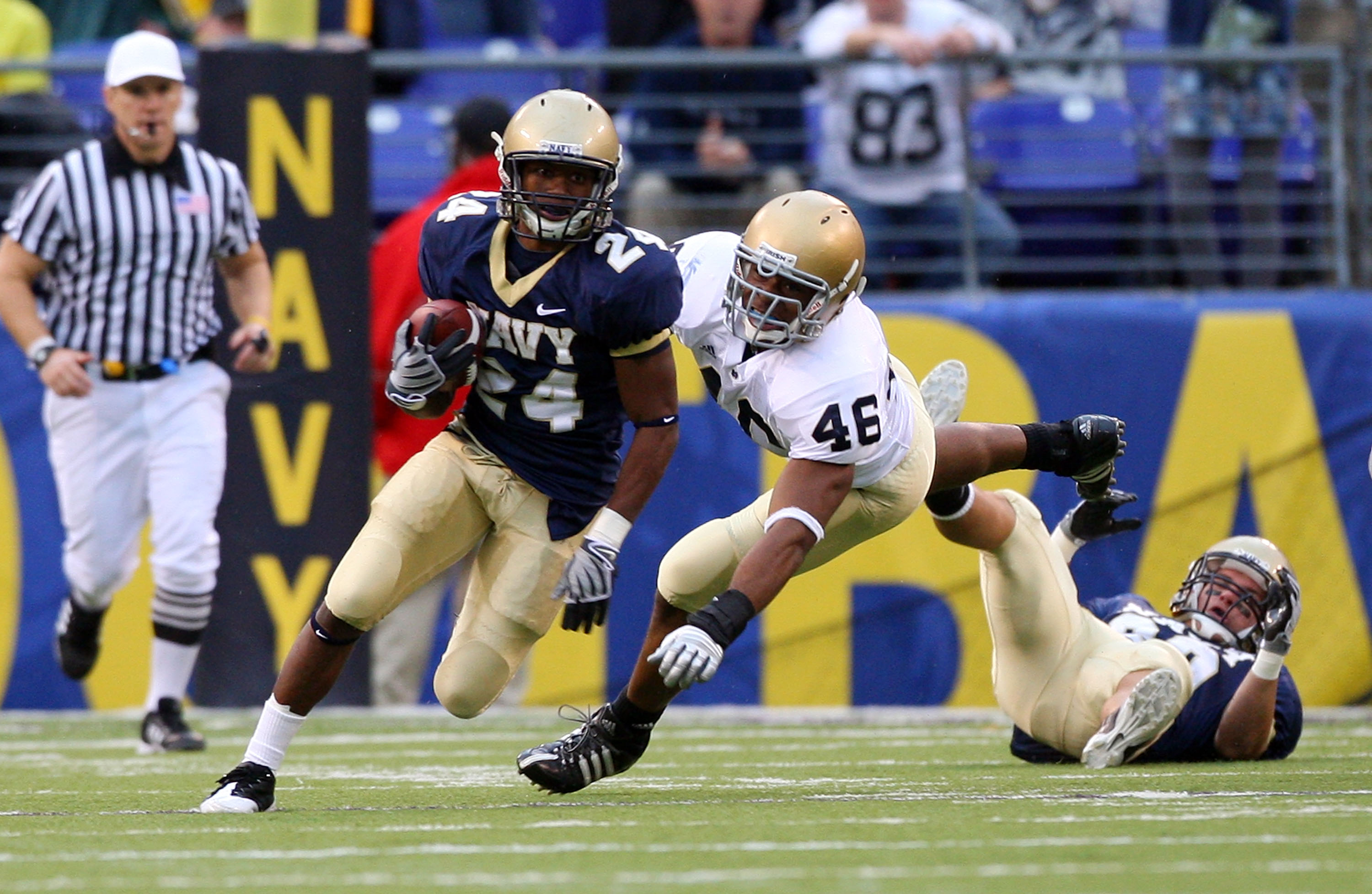 BALTIMORE - NOVEMBER 15:  Corey James #24 of the Navy Midshipmen returns a punt past Steve Filer #46 of the Notre Dame Fighting Irish on November 15, 2008 at M&T Bank Stadium in Baltimore, Maryland. Notre Dame defeated Navy 27-21.  (Photo by Jim McIsaac/G