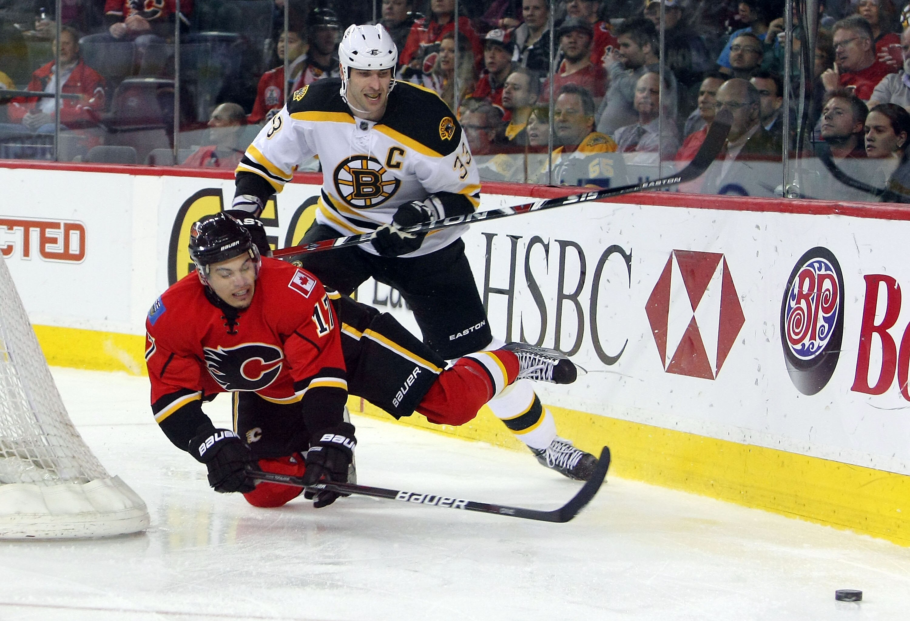 CALGARY,CANADA - FEBRUARY 22:  Zdeno Chara #33 of the Boston Bruins battles for the puck against Rene Bourque #17 of the Calgary Flames during their NHL game at Scotiabank Saddledome, February 22,2011 in Calgary, Alberta, Canada.(Photo By Dave Sandford/Ge