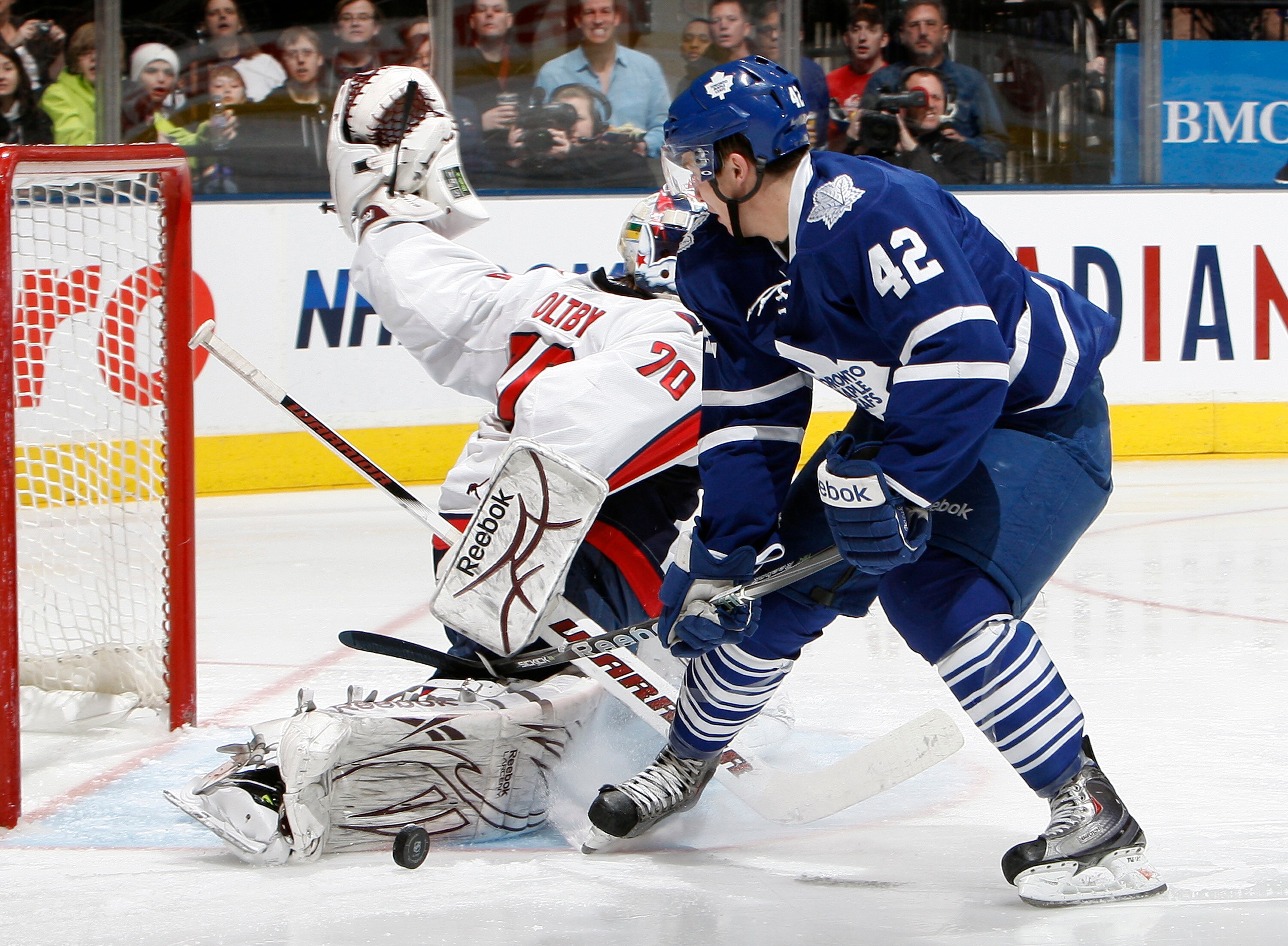 TORONTO, CANADA - JANUARY 22: Tyler Bozak #42 of the Toronto Maple Leafs gets stopped by Braden Holtby #70 of the Washington Capitals during game action at the Air Canada Centre January 22, 2011 in Toronto, Ontario, Canada. (Photo by Abelimages/Getty Imag
