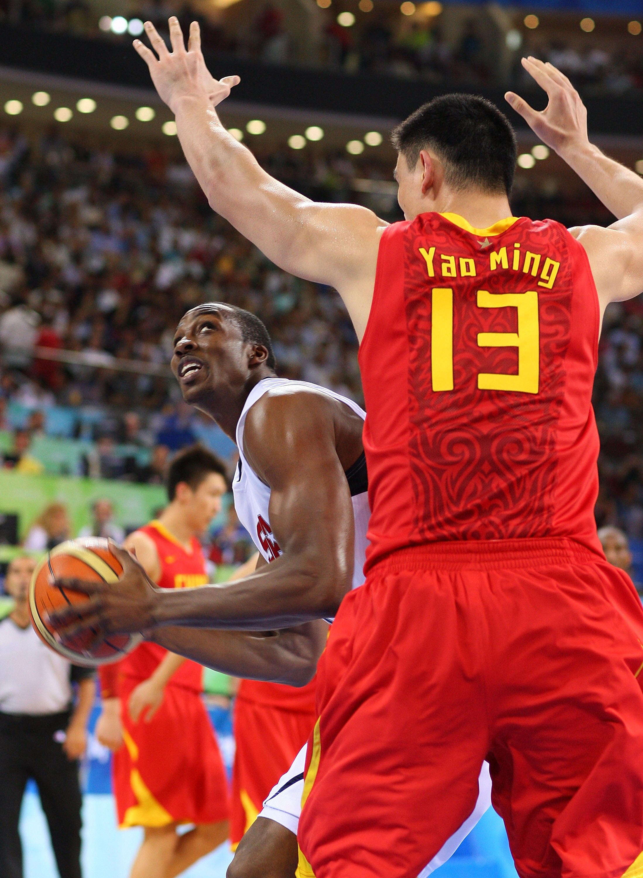 BEIJING - AUGUST 10:  Dwight Howard #11 of the United States look for an opening around Yao Ming #13 of China during the day 2 preliminary game at the Beijing 2008 Olympic Games in the Beijing Olympic Basketball Gymnasium on August 10, 2008 in Beijing, Ch
