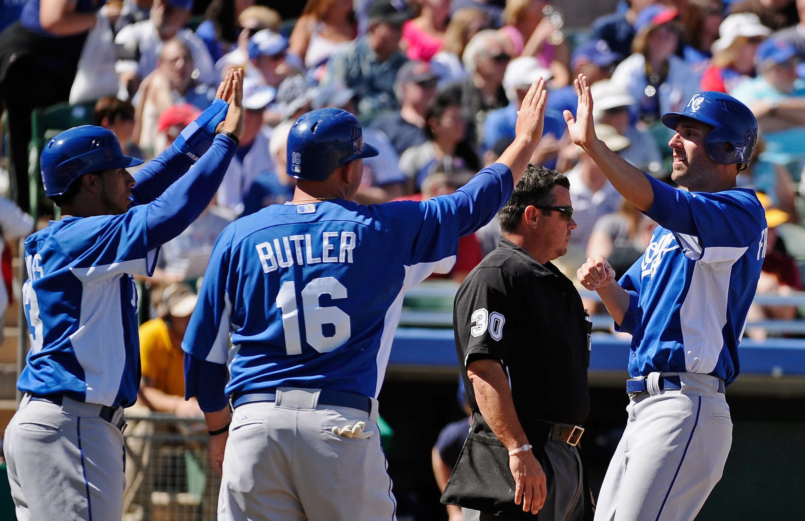 MESA, AZ - MARCH 09: Mike Aviles #13, Billy Butler #16 and Jeff Francoeur #21 of the Kansas City Royals celebrate after they all scored on a triple by teammate Melky Cabrera #53 in the first inning against pitcher Matt Garza #17 of the Chicago Cubs durin MESA, AZ - MARCH 09: Mike Aviles #13, Billy Butler #16 and Jeff Francoeur #21 of the Kansas City Royals celebrate after they all scored on a triple by teammate Melky Cabrera #53 in the first inning against pitcher Matt Garza #17 of the Chicago Cubs durin