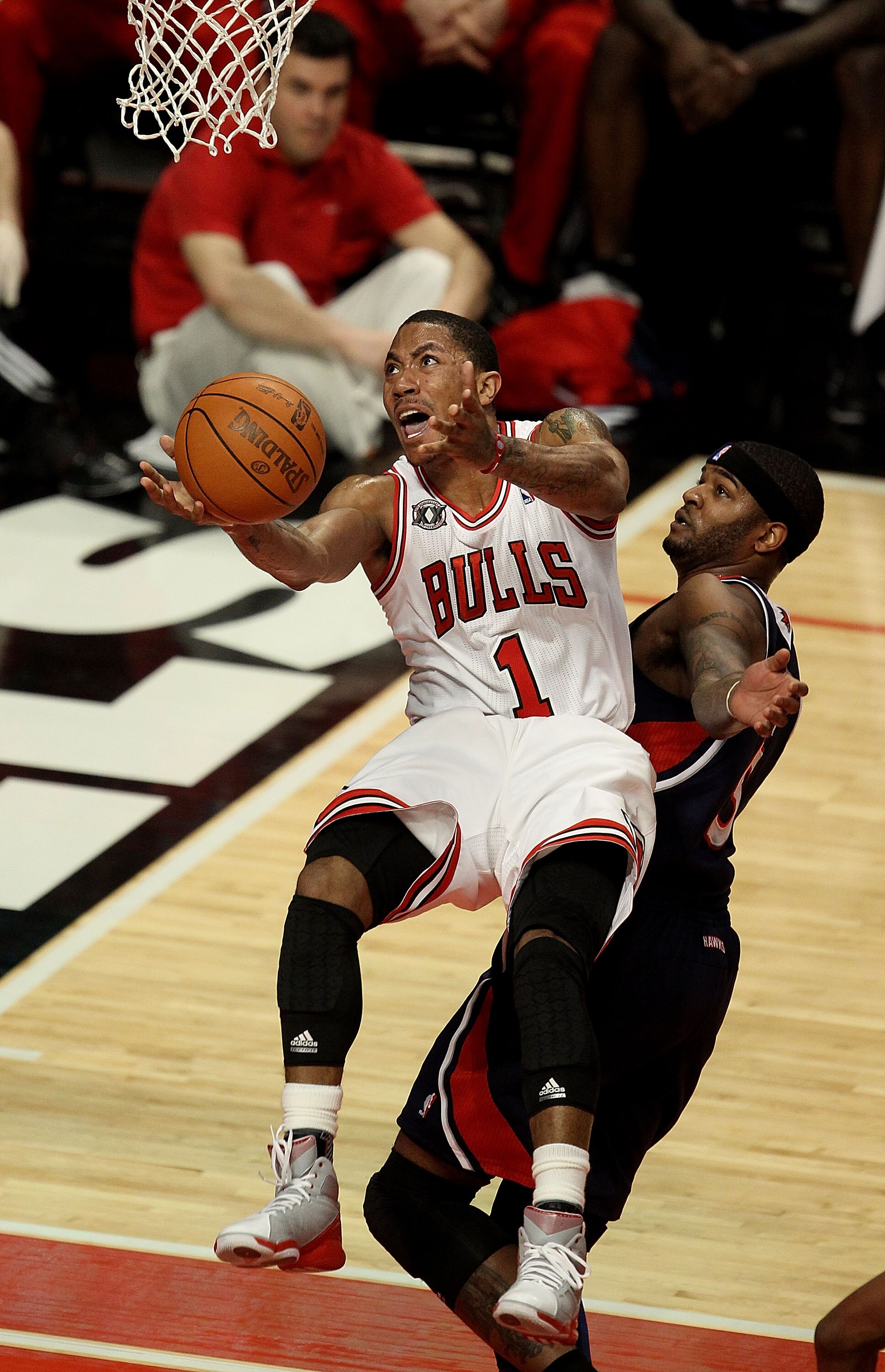 CHICAGO, IL - MARCH 11: Derrick Rose #1 of the Chicago Bulls puts up a shot against Josh Smith #5 of the Atlanta Hawks on his way to a game-high 34 points at the United Center on March 11, 2011 in Chicago, Illinois. The Bulls defeated the Hawks 94-76. NOT