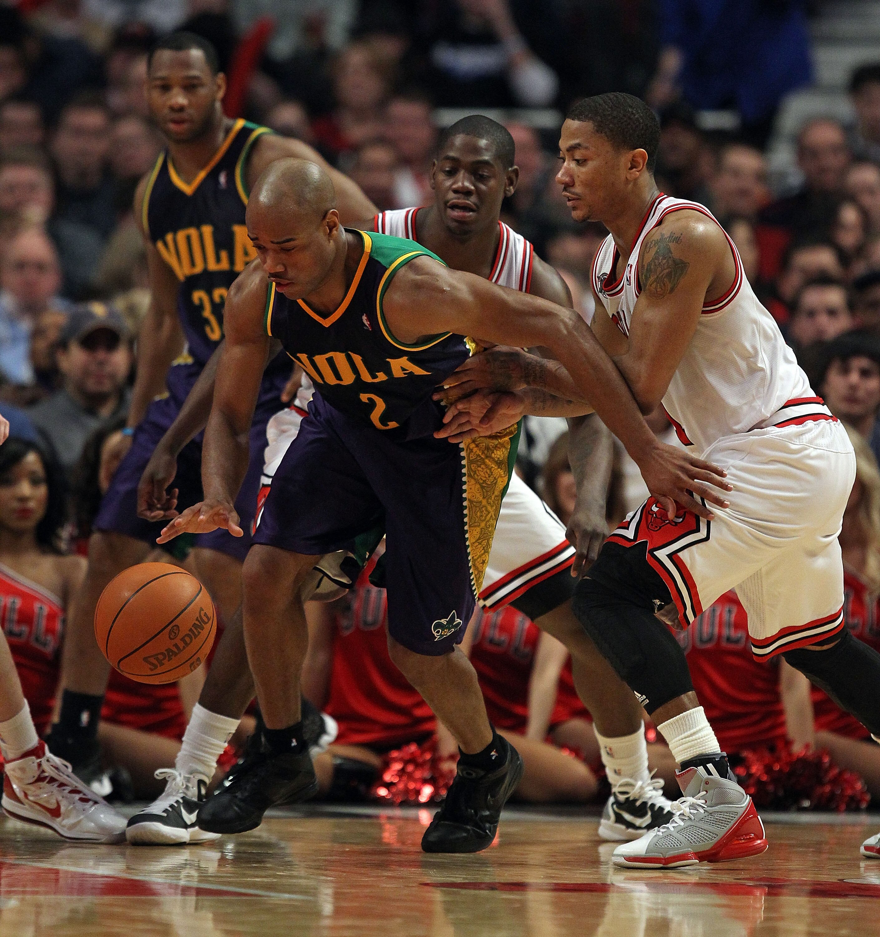 CHICAGO, IL - MARCH 07: Jarrett Jack #2 of the New Orleans Hornets moves against Derrick Rose #1 of the Chicago Bulls at the United Center on March 7, 2011 in Chicago, Illinois. The Bulls defeated the Hornets 85-77. NOTE TO USER: User expressly acknowledg