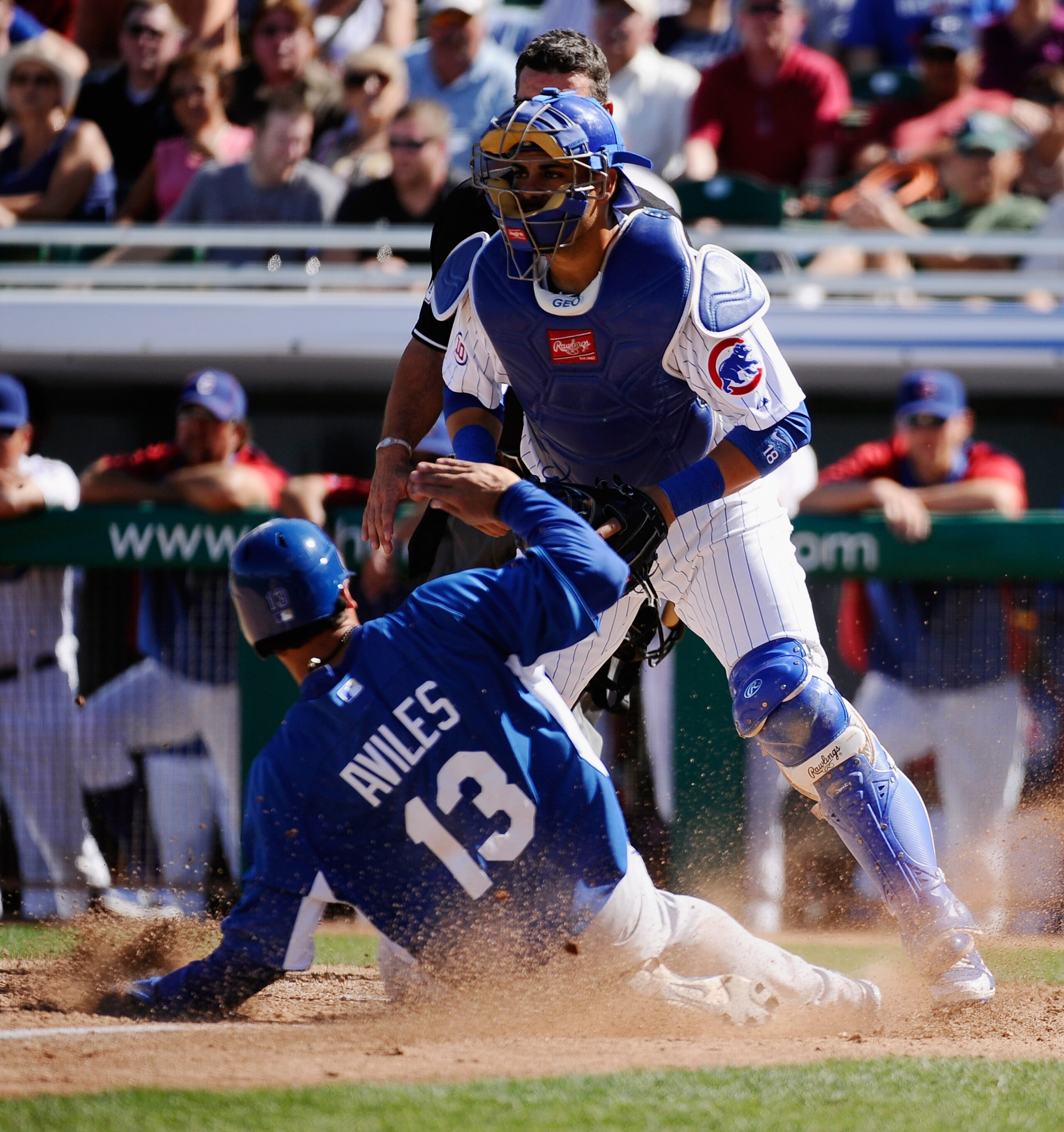 MESA, AZ - MARCH 09: Catcher Geovany Soto #18 of the Chicago Cubs looks for the throw to home plate as Mike Aviles #13 of the Kansas City Royals scores a run in the fourth inning of the spring training baseball game at HoHoKam Stadium on March 9, 2011 in MESA, AZ - MARCH 09: Catcher Geovany Soto #18 of the Chicago Cubs looks for the throw to home plate as Mike Aviles #13 of the Kansas City Royals scores a run in the fourth inning of the spring training baseball game at HoHoKam Stadium on March 9, 2011 in