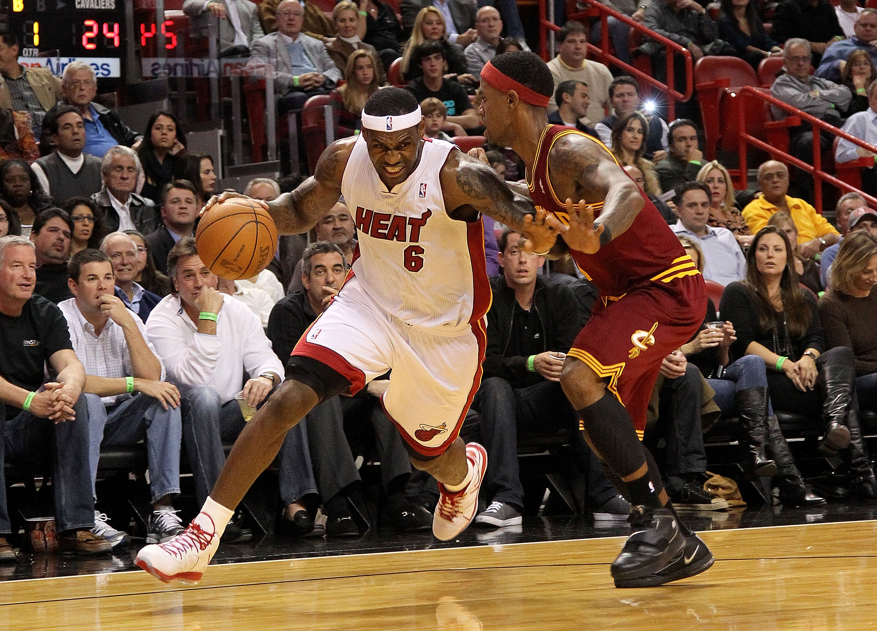 MIAMI, FL - DECEMBER 15:  LeBron James #6 of the Miami Heat dribbles around Daniel Gibson #1 of the Cleveland Cavaliers during a game  at American Airlines Arena on December 15, 2010 in Miami, Florida. NOTE TO USER: User expressly acknowledges and agrees 