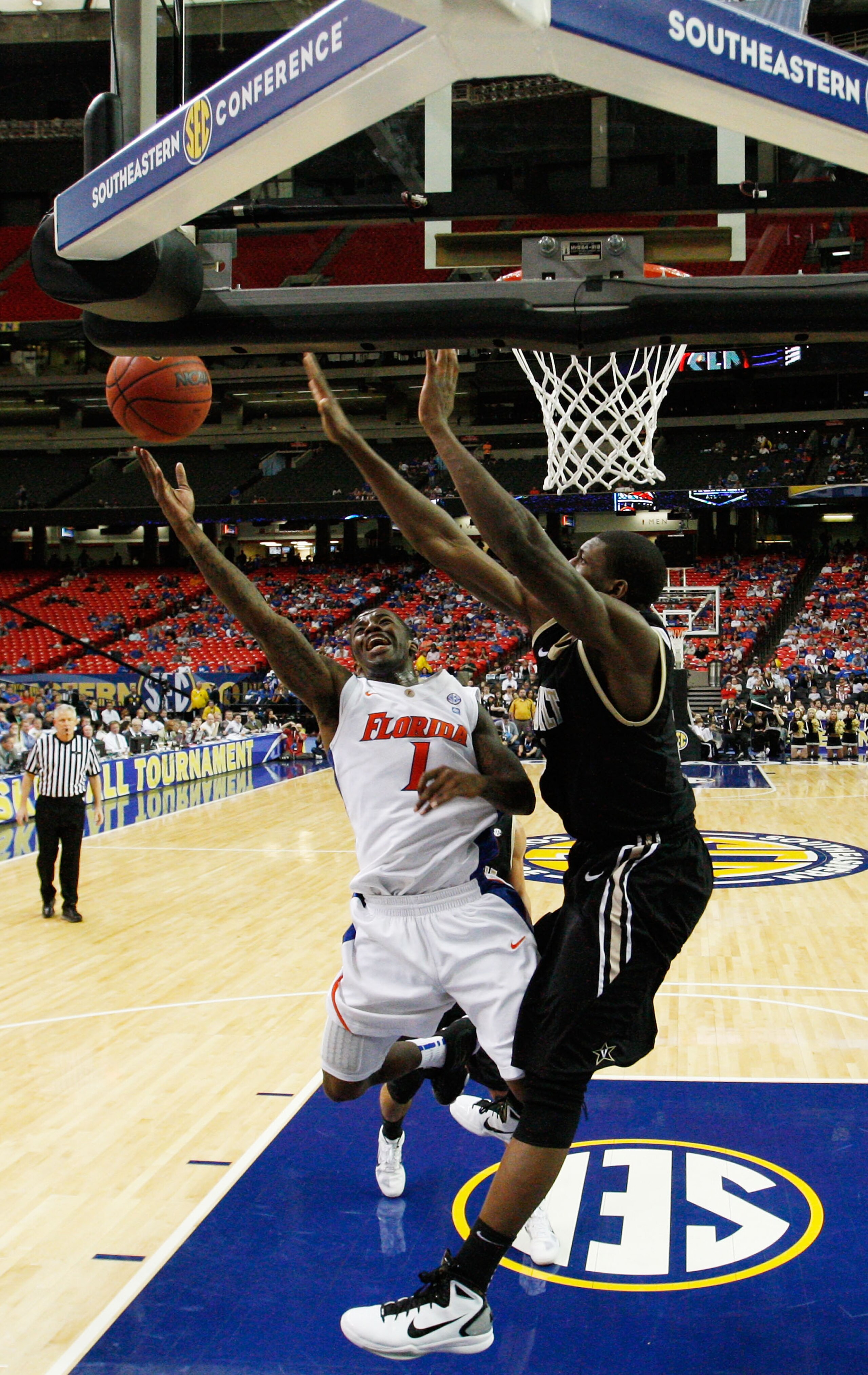 ATLANTA, GA - MARCH 12:  Kenny Boynton #1 of the Florida Gators shoots against Festus Ezeli #3 of the Vanderbilt Commodores during the semifinals of the SEC Men's Basketball Tournament at Georgia Dome on March 12, 2011 in Atlanta, Georgia.  (Photo by Kevi