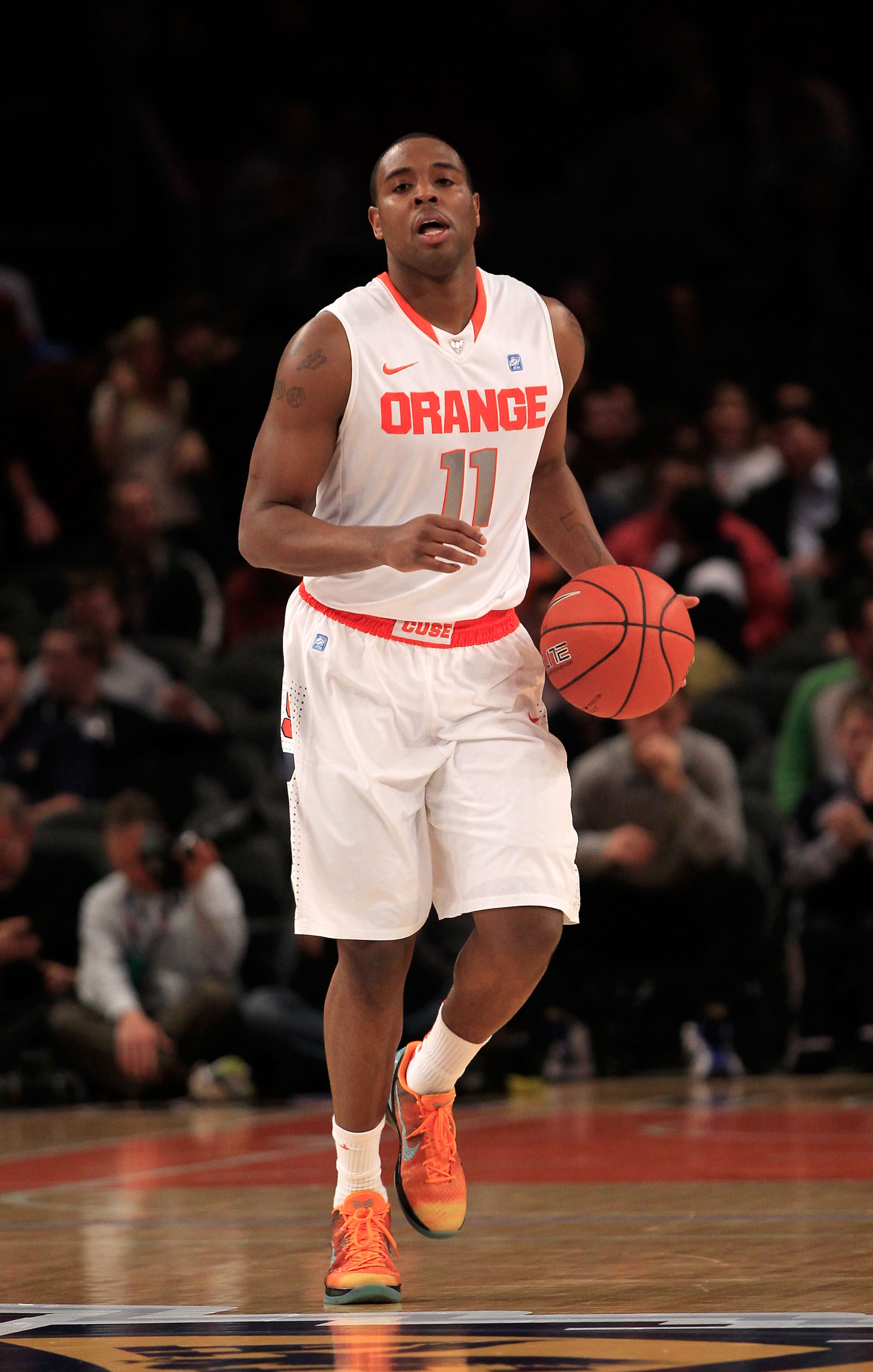 NEW YORK, NY - MARCH 11: Scoop Jardine #11 of the Syracuse Orange brings the ball up court against the Connecticut Huskies during the semifinals of the 2011 Big East Men's Basketball Tournament presented by American Eagle Outfitters at Madison Square Gard NEW YORK, NY - MARCH 11: Scoop Jardine #11 of the Syracuse Orange brings the ball up court against the Connecticut Huskies during the semifinals of the 2011 Big East Men's Basketball Tournament presented by American Eagle Outfitters at Madison Square Gard