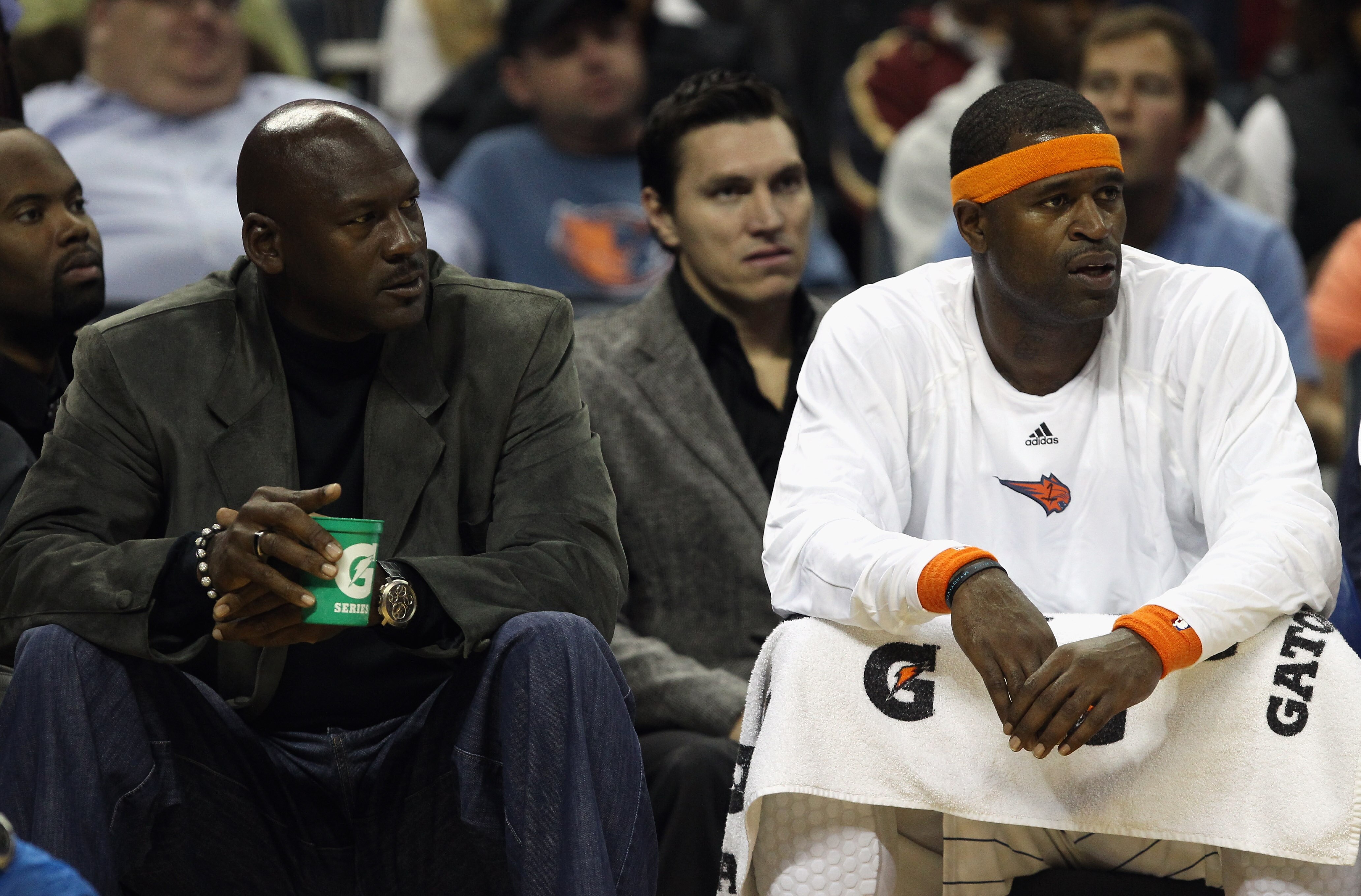 CHARLOTTE, NC - NOVEMBER 08:  Michael Jordan, owner of the Charlotte Bobcats, sits on the bench with Stephen Jackson #1 during their game against the San Antonio Spurs at Time Warner Cable Arena on November 8, 2010 in Charlotte, North Carolina.  NOTE TO U