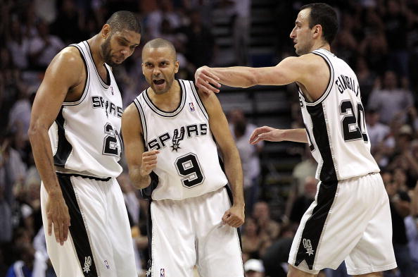 SAN ANTONIO - APRIL 23: Tony Parker #9 of the San Antonio Spurs reacts with Tim Duncan #21 and Manu Ginobili #20 against the Dallas Mavericks in Game Three of the Western Conference Quarterfinals during the 2010 NBA Playoffs at AT&T Center on April 23, 20